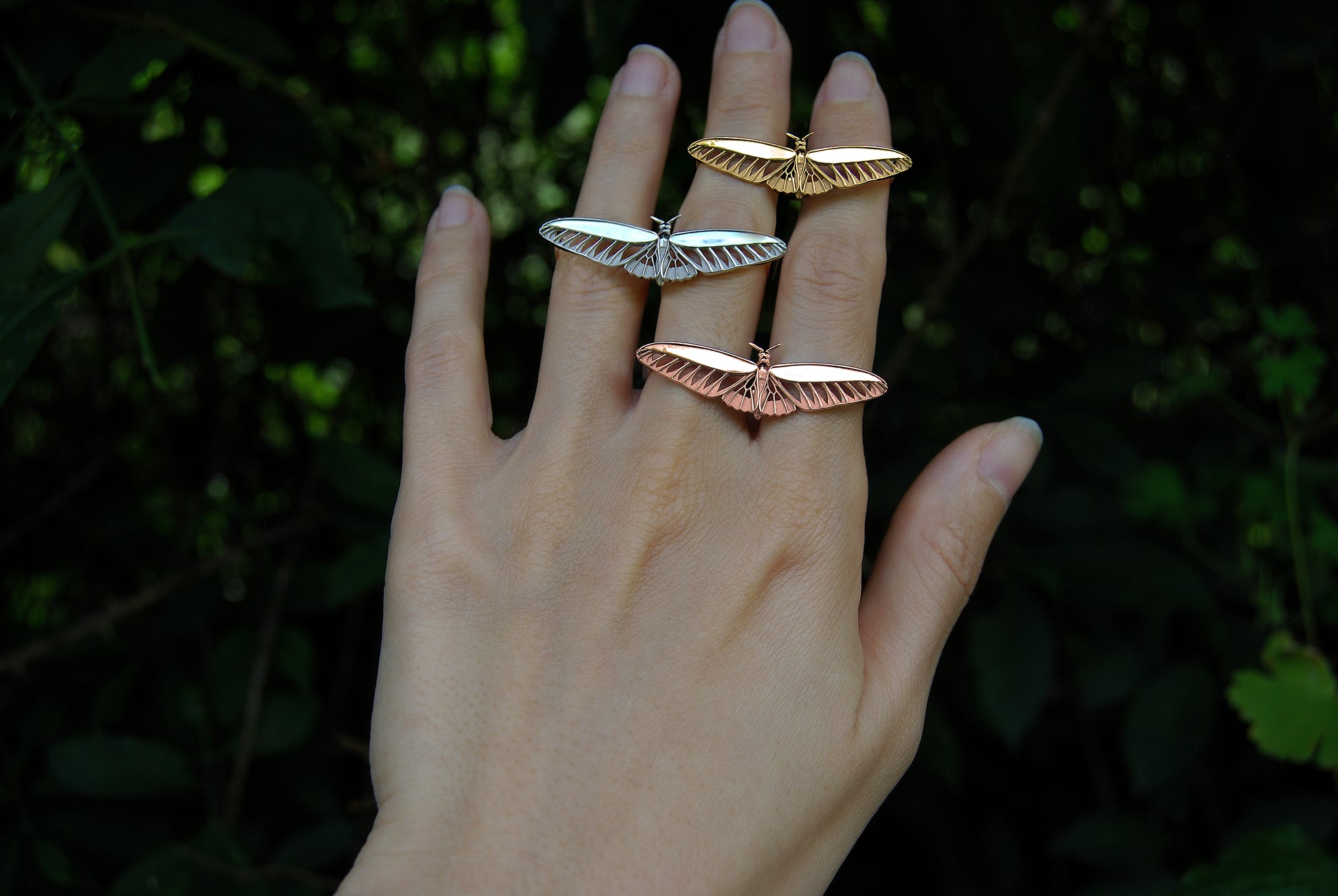 14K gold plated, rose gold plated, and sterling silver butterfly rings worn on hand, showcasing color variations.