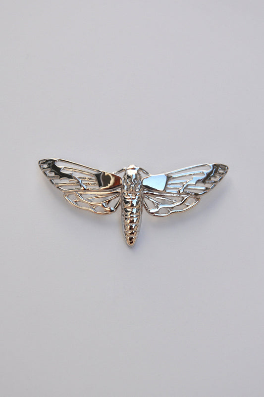 Front view of the Death’s-head Hawk Moth pendant in sterling silver on a white background, showing intricate skull and wing details.