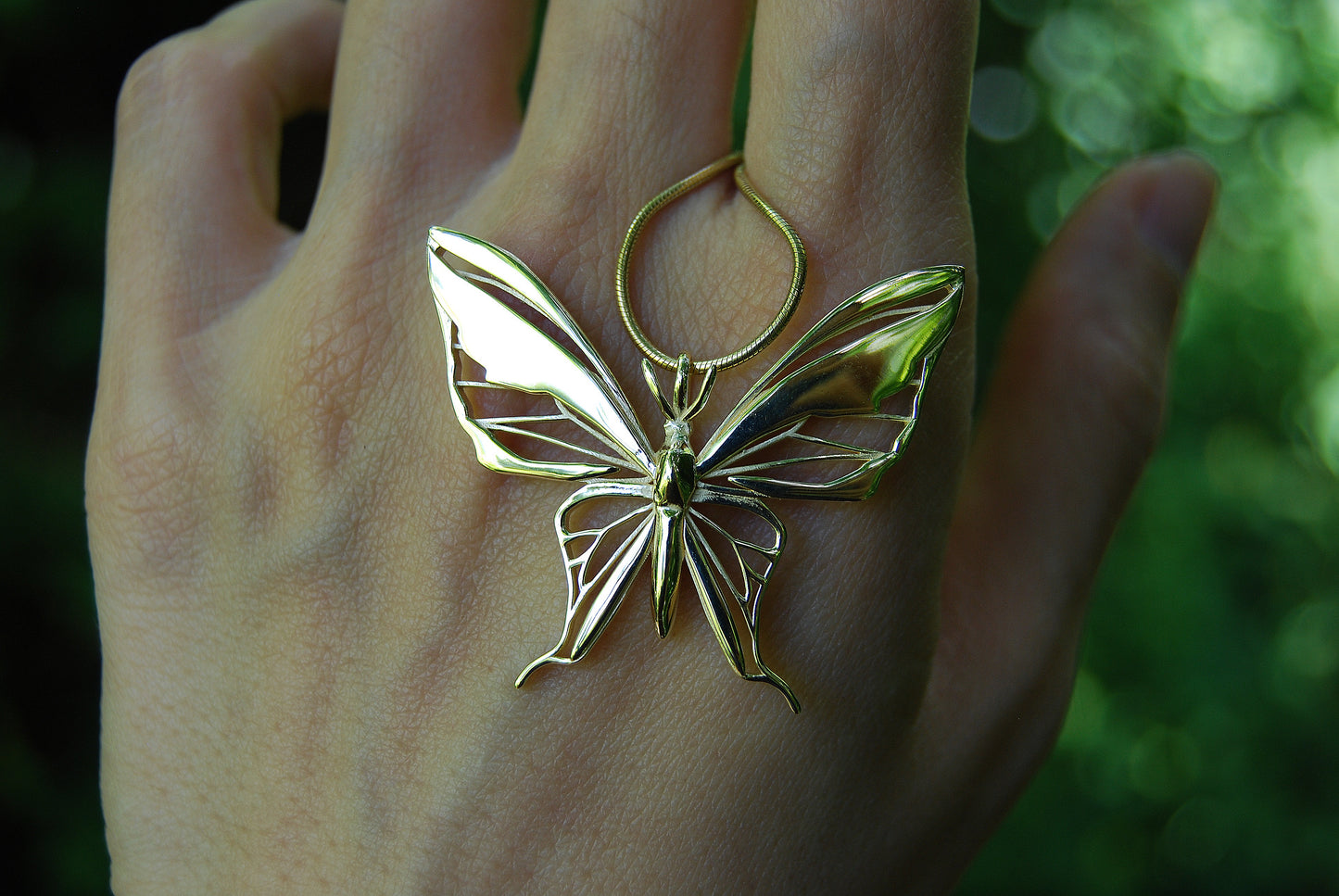 Detailed view of gold butterfly pendant necklace