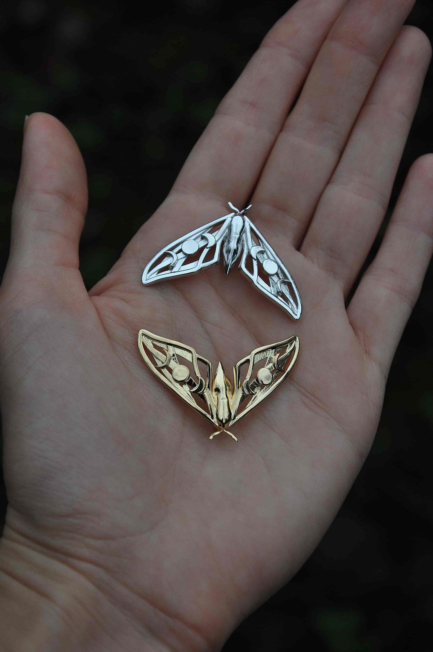 Display of gold and silver Hawk Moth Pendants together, celebrating transformation and lunar cycles in dual tones.