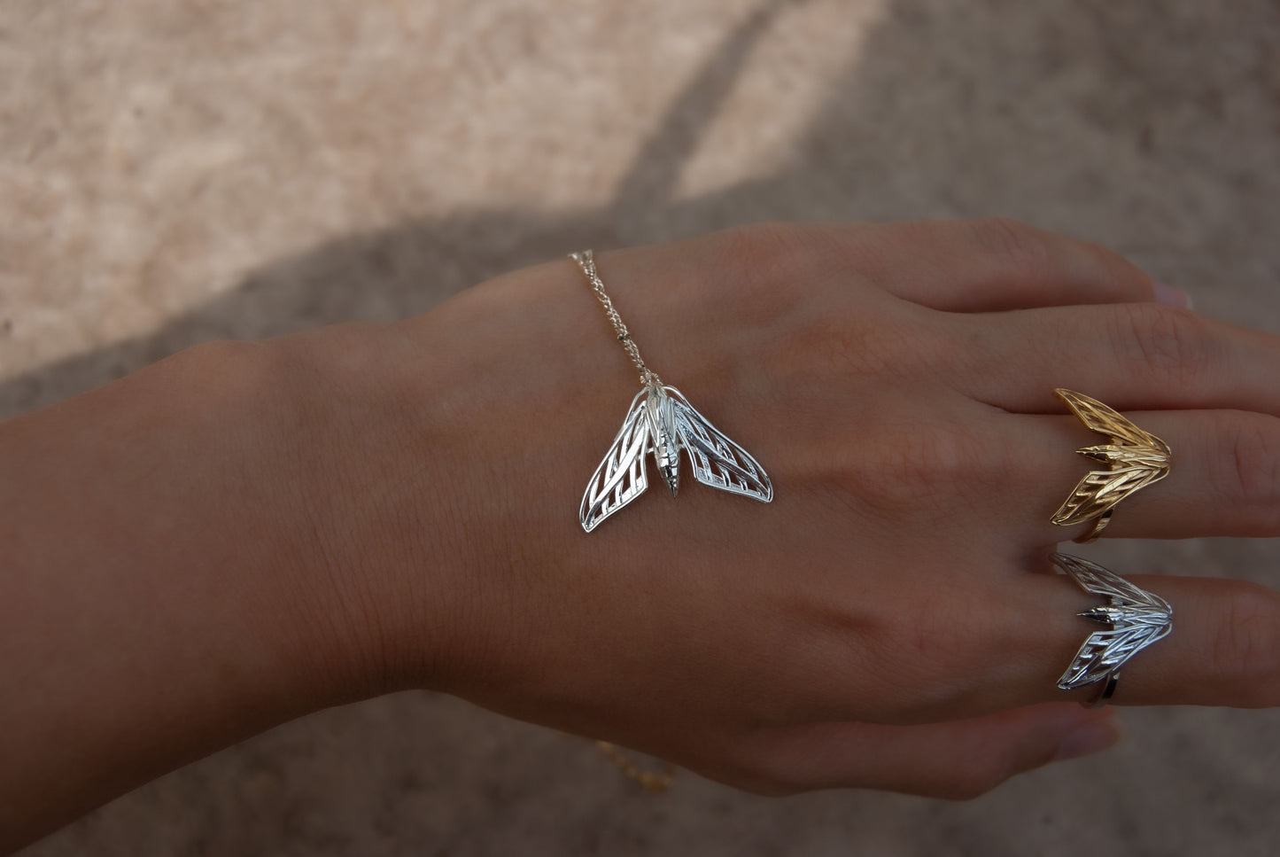 Handcrafted sphinx moth jewelry set in mixed metals