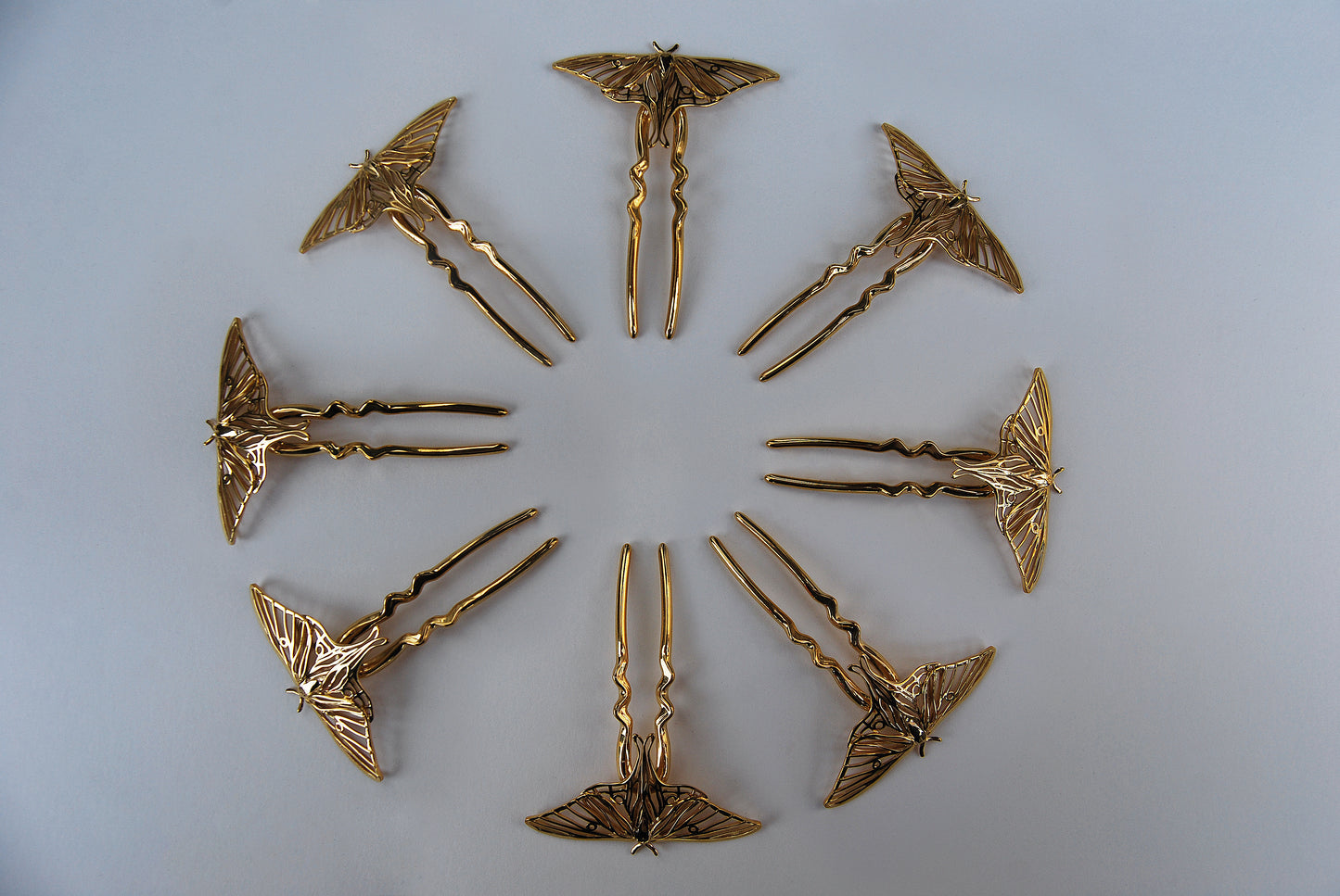 14k gold-plated Luna Moth mandala displayed on a white background, showcasing intricate wing patterns and symmetrical design inspired by nature and sacred geometry.
