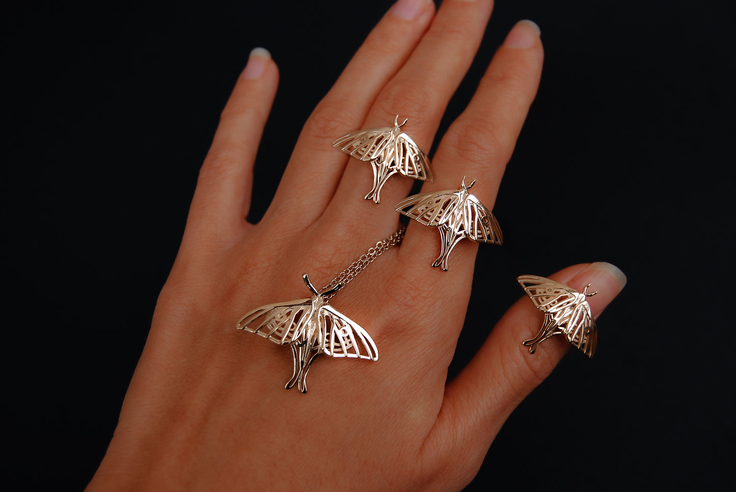 Another view of the silver Luna Moth Ring on hand, highlighting the intricate structure of the moth wings.