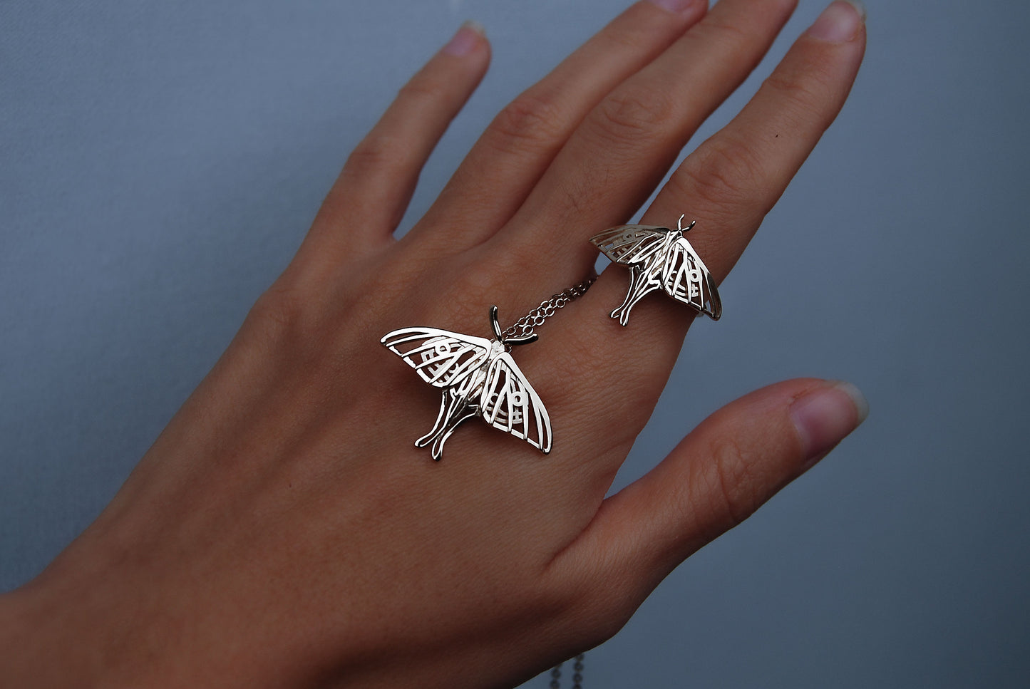 Silver Luna Moth Ring worn on hand alongside matching pendant, highlighting the cohesive moth jewelry set.
