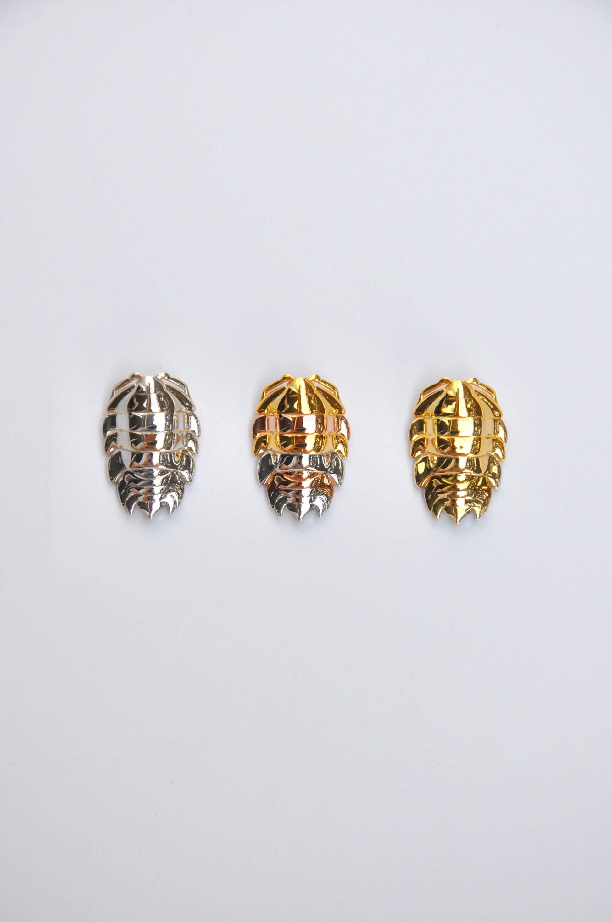Handmade mixed metal rainbow isopod pendant with sterling silver and 14k gold plating, inspired by entomology and insect jewelry trends