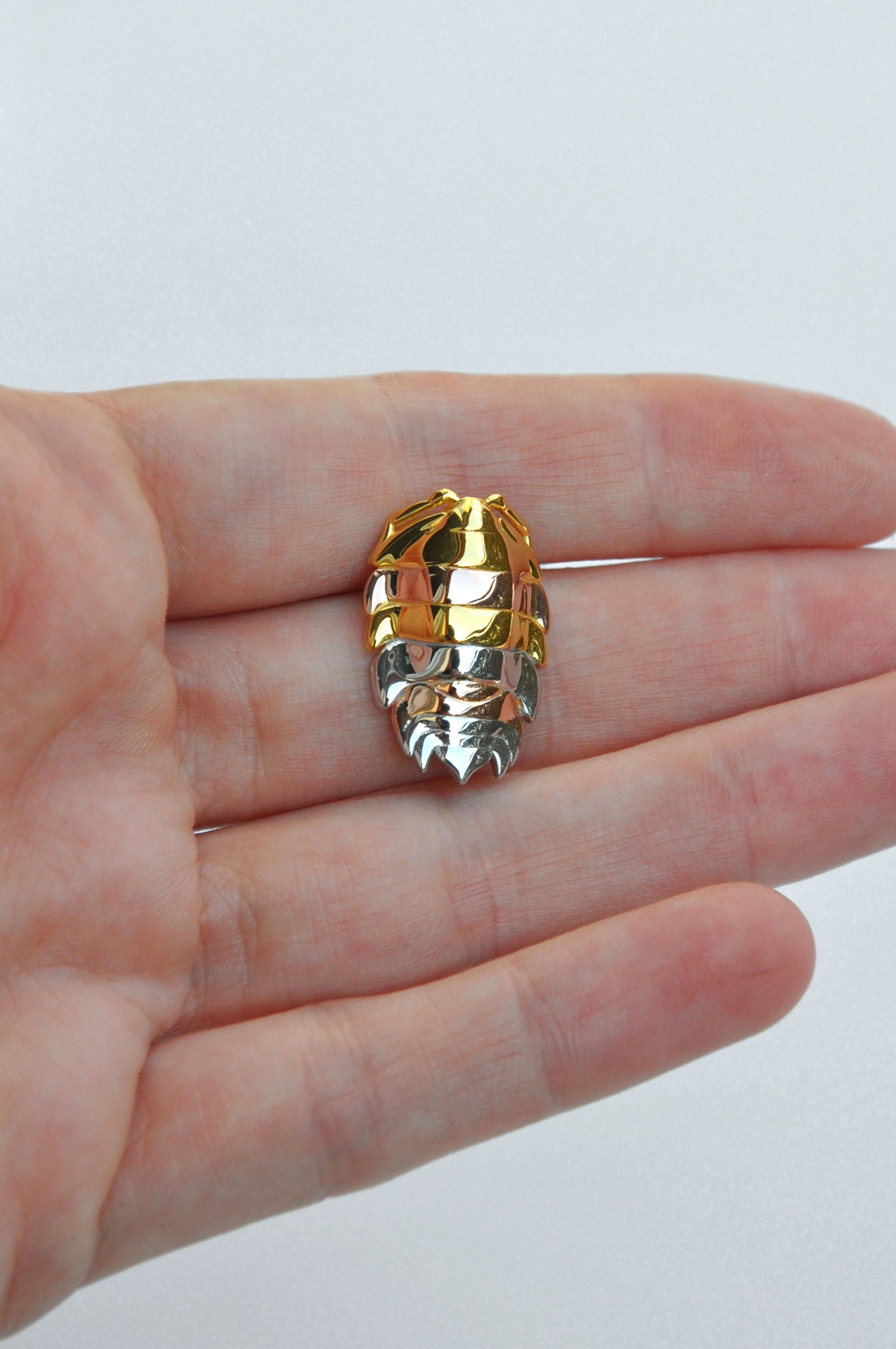 Mixed metal rainbow isopod pendant showcasing vibrant colors and detailed bug design, ideal for unique insect jewelry collections