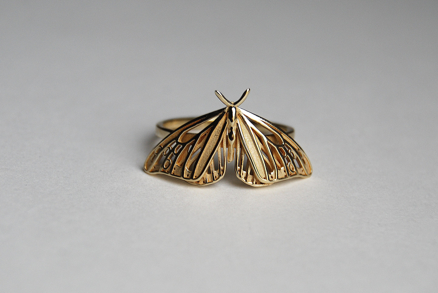 Gold Monarch Butterfly ring with Art Nouveau design on white background