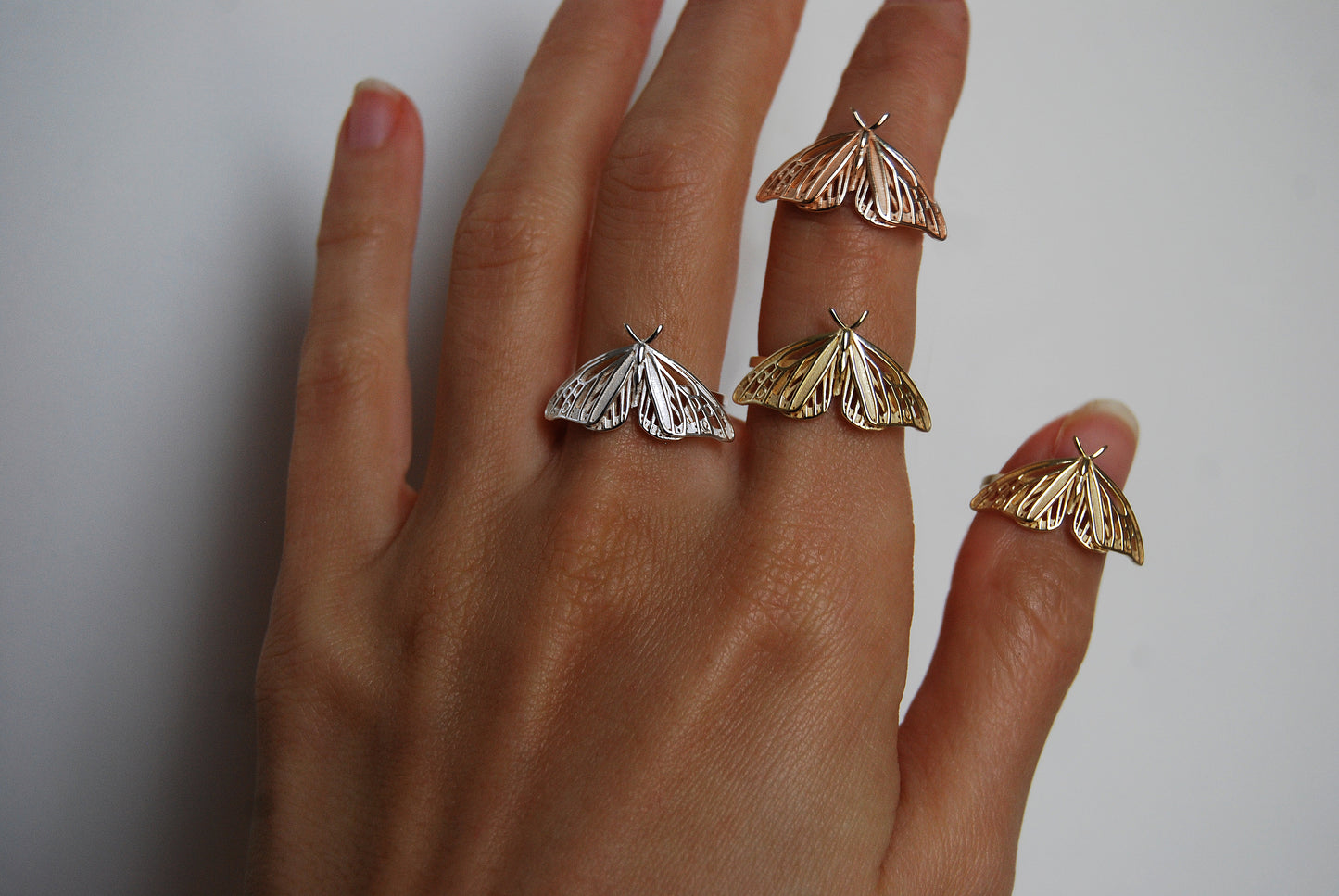 Trio of Monarch Butterfly rings in gold, rose gold, and silver finishes