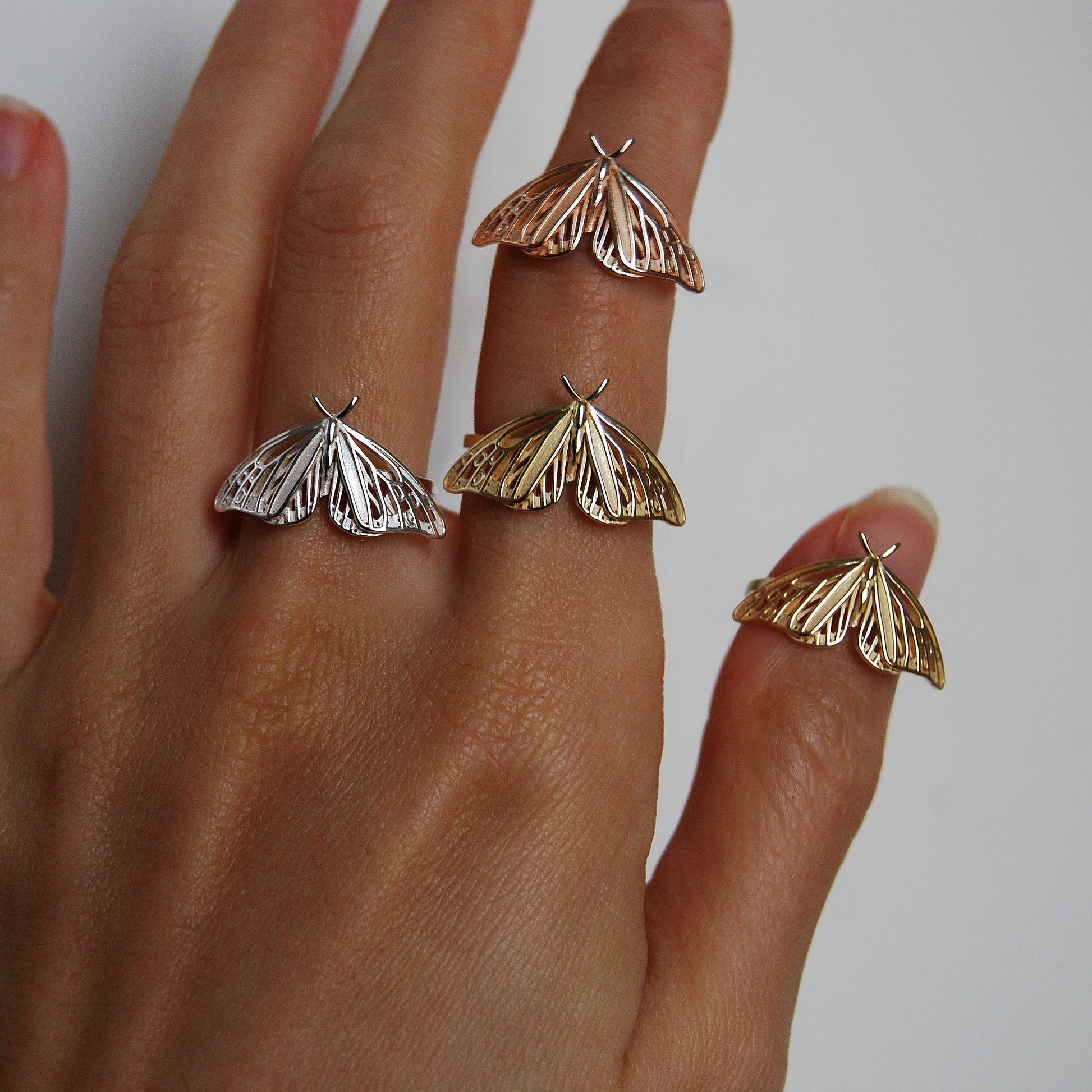 Trio of Monarch Butterfly rings in gold, rose gold, and silver finishes