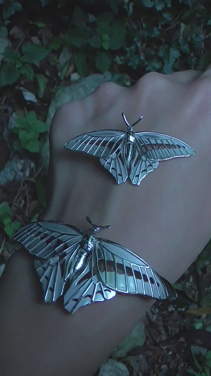 Video of Blue Triangle Butterfly pendant and bracelet set, highlighting handmade details and shimmering silver finish.