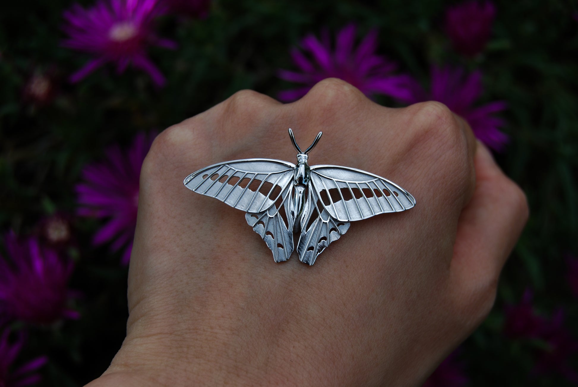 Close-up front view of the sterling silver Blue Triangle Butterfly pendant, highlighting detailed wing patterns and polished finish.