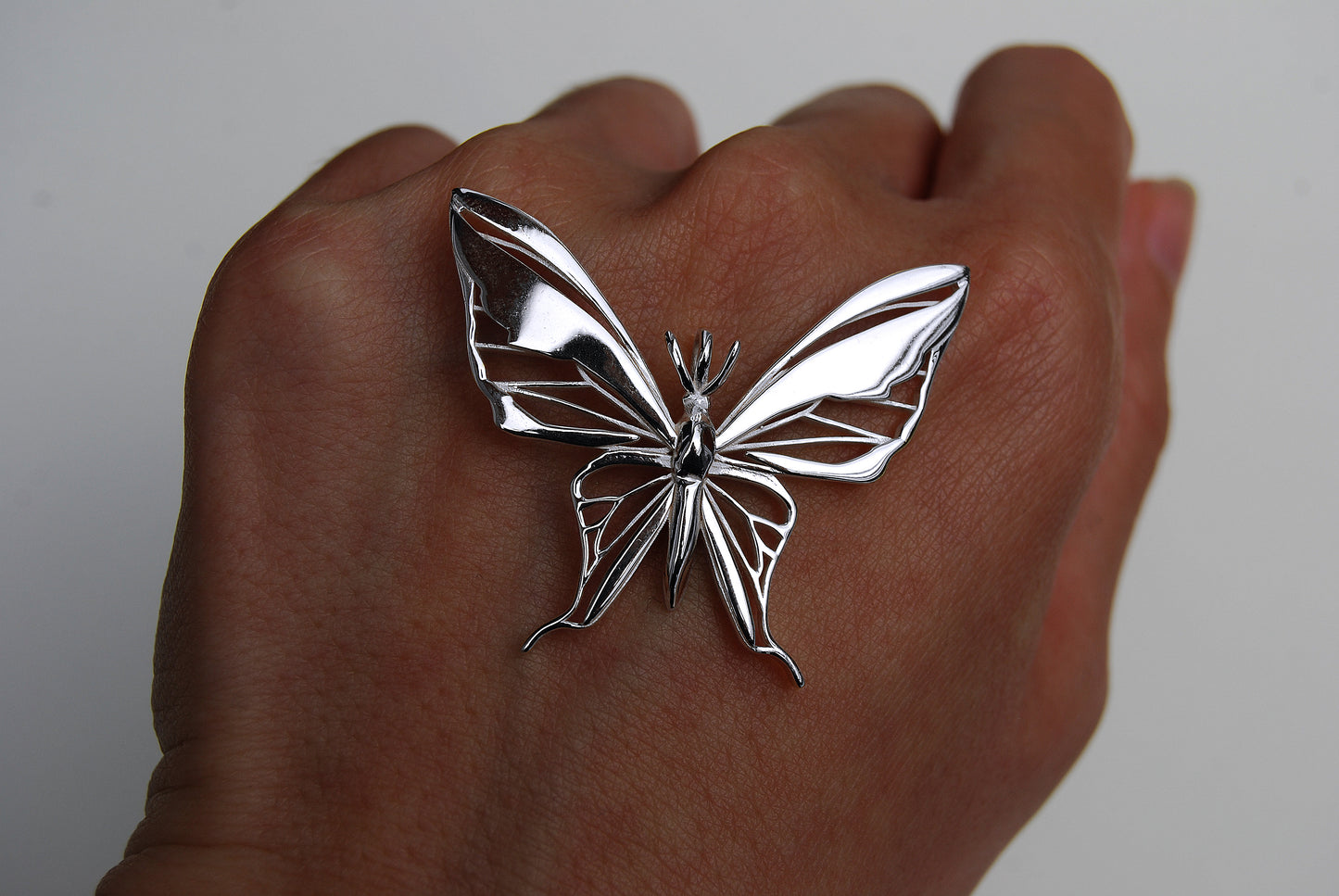Sterling silver butterfly pendant necklace on white background