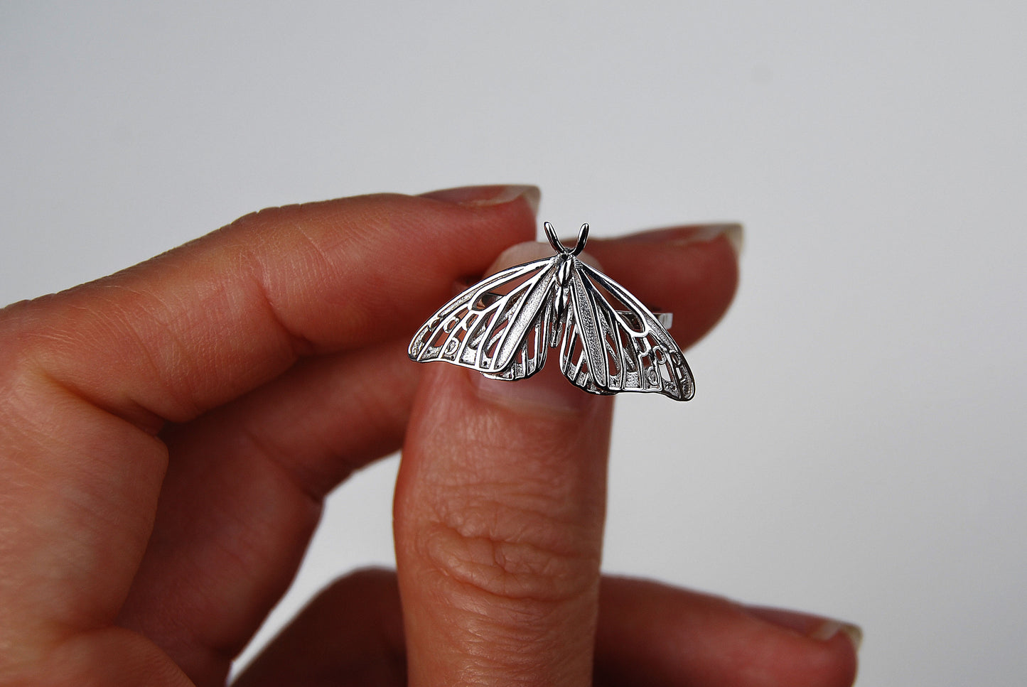 Close-up of silver monarch butterfly ring with Art Nouveau design