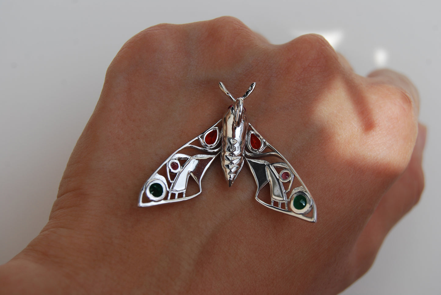 Close-up detail of enamel work on silver moth pendant necklace back2