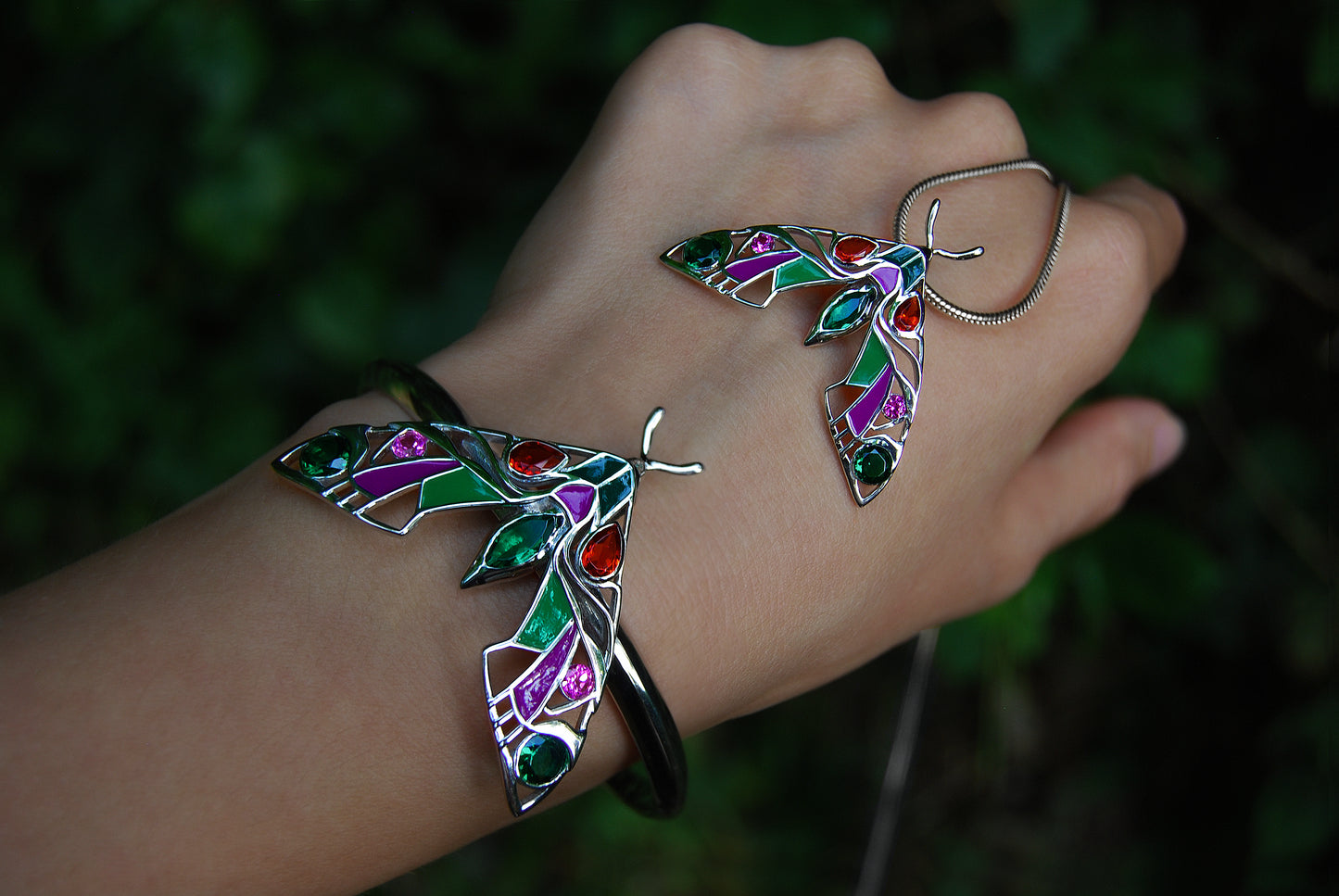 Close-up detail of enamel work on silver moth pendant necklace
