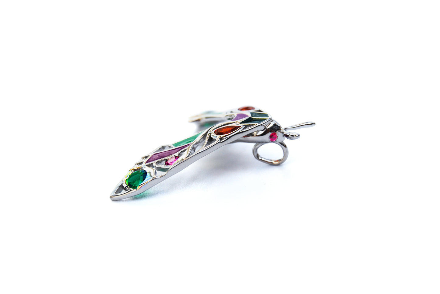 Side view of silver moth pendant necklace on white background