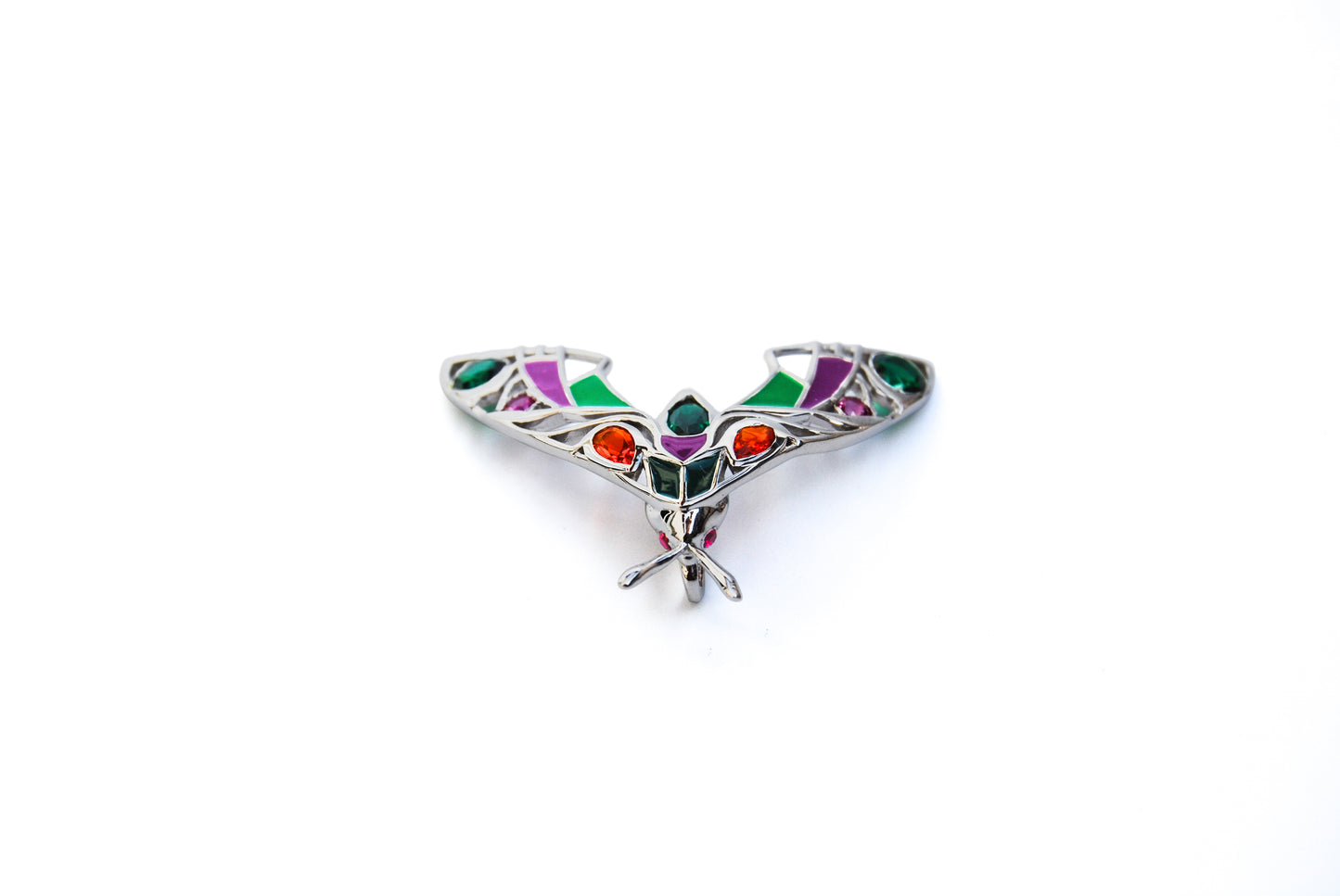 Top view of silver moth pendant necklace on white background
