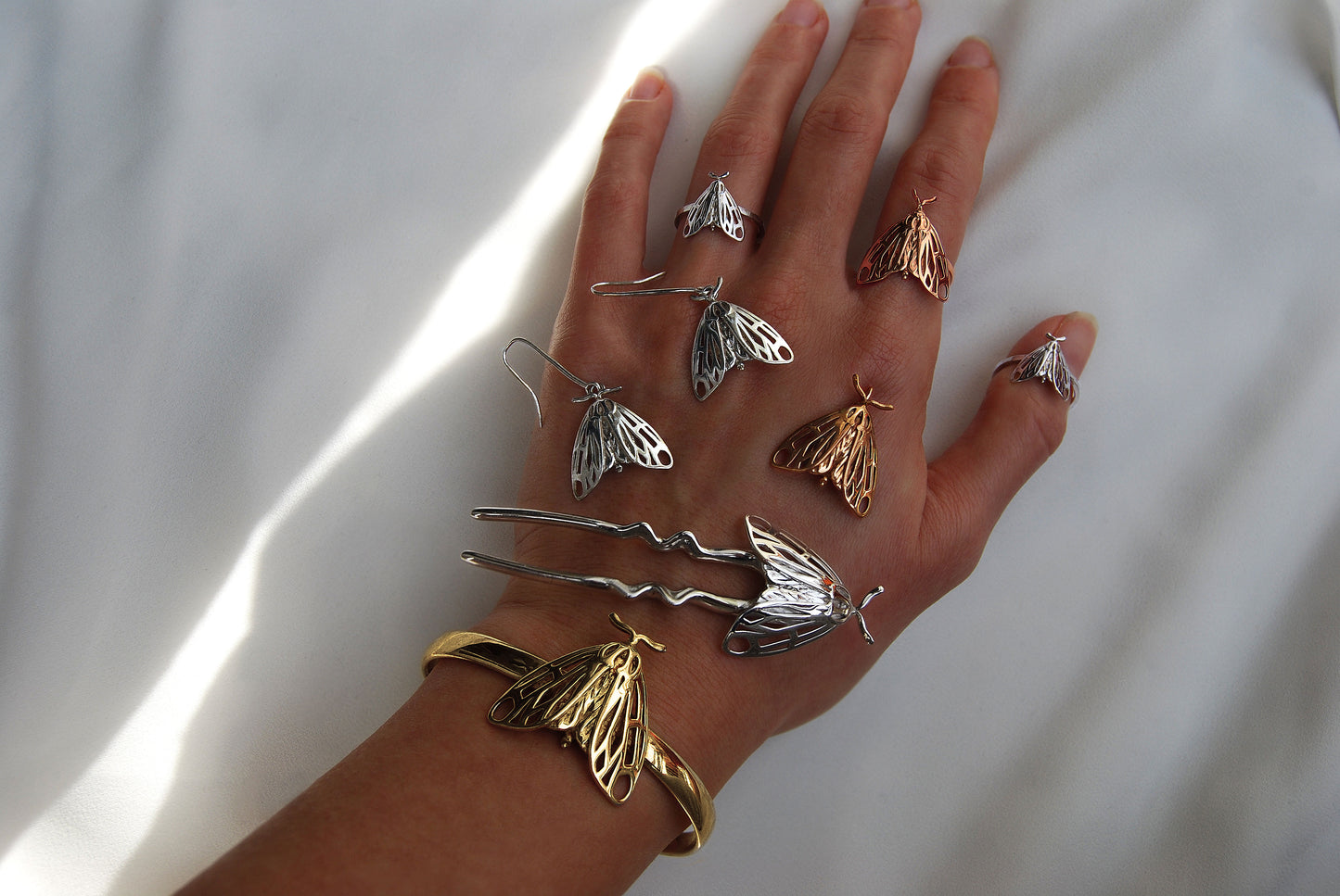 Full Tiger Moth Ring collection in silver and gold finishes worn on hand, showcasing bug jewelry styling.