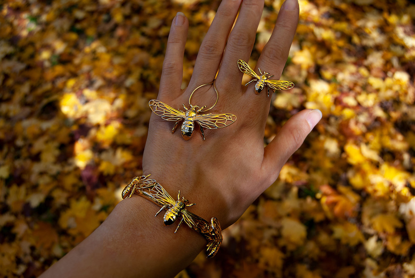 Gold bee bracelet cuff worn on hand