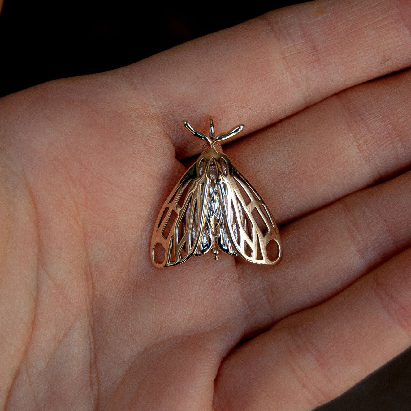Detailed close-up of tiger moth insect necklace, ideal for lovers of entomology jewelry pieces