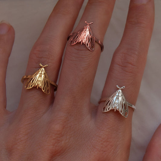 Tiger Moth Rings in sterling silver, 14K gold plated, and 14K rose gold plated finishes worn on finger.