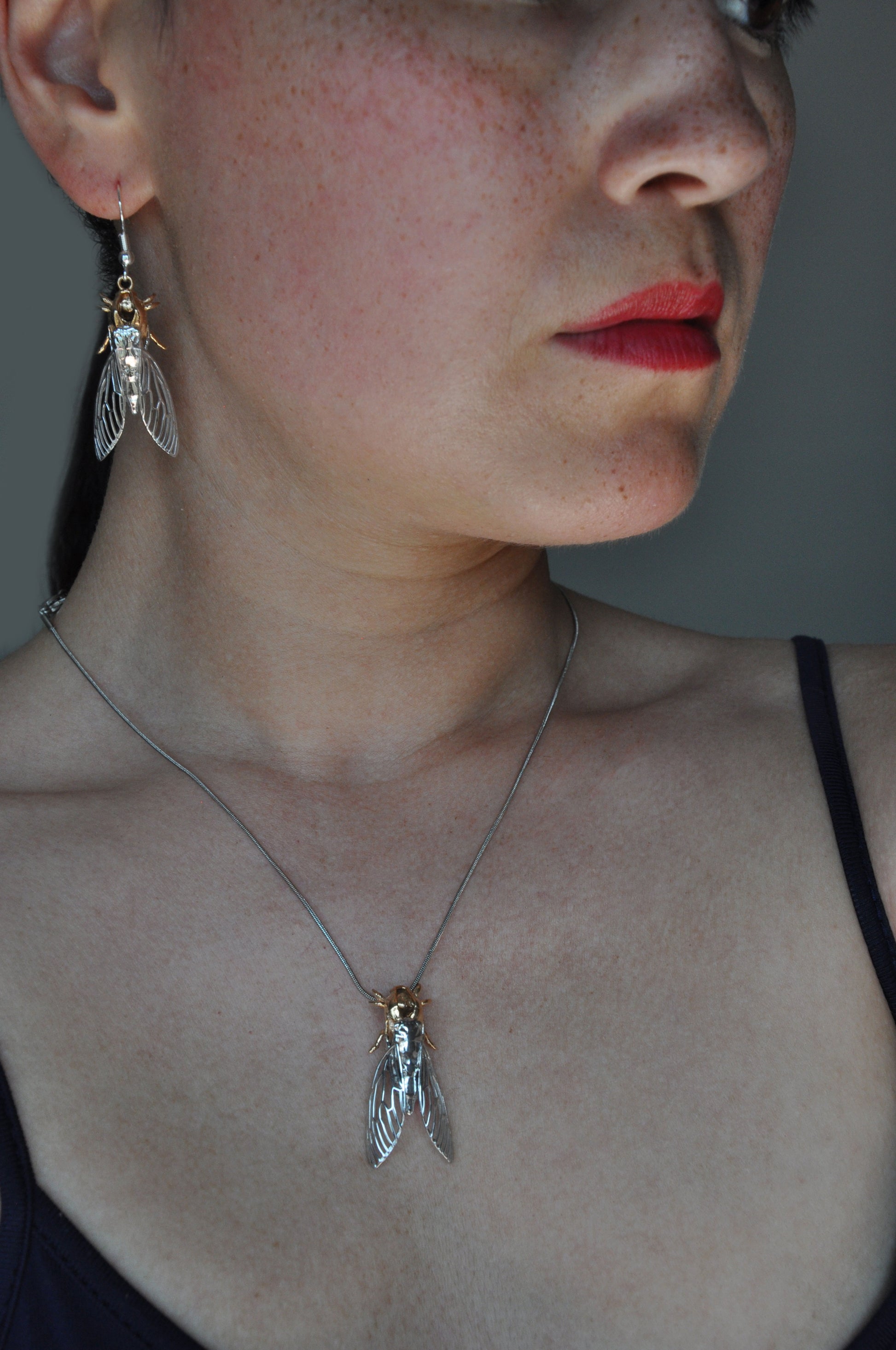 Silver cicada with attached shell pendant, perfect for bug jewelry collectors