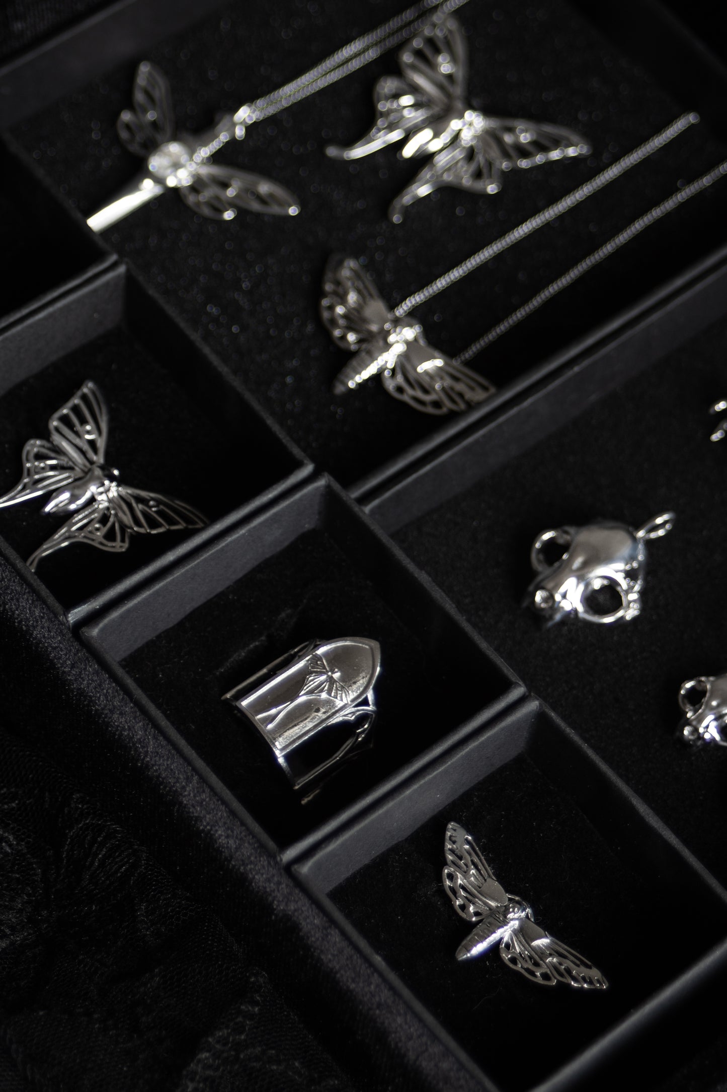 Gothic jewelry from The Specter’s Cabinet collection featuring silver Luna moth, cathedral, and cat skull designs by Anna Reikher