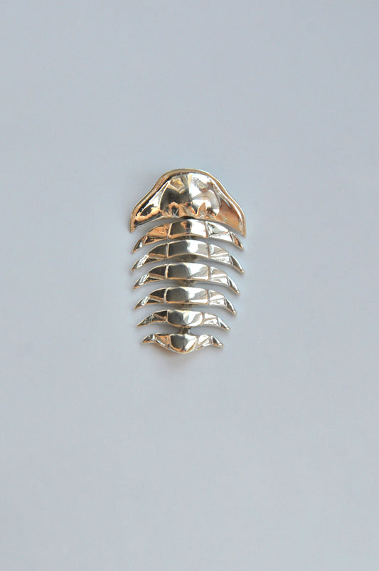 Sterling silver articulated trilobite pendant displayed on a white background. The pendant features segmented, movable sections that mimic the natural symmetry of the prehistoric trilobite fossil. Its sleek, polished finish highlights the craftsmanship and modern design inspired by ancient marine life.