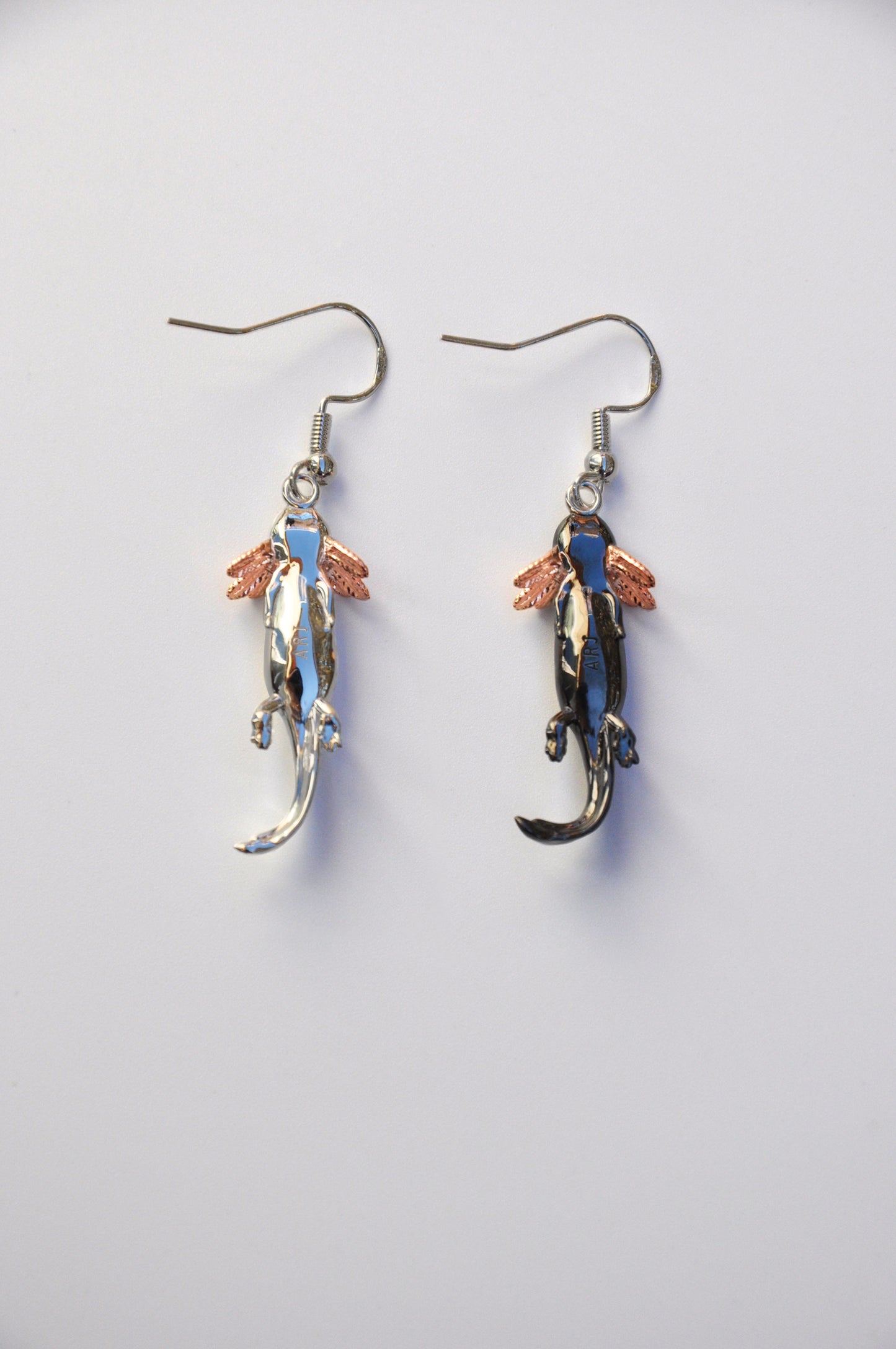 Back view of the Axolotl Drop Earrings on a white background, highlighting the smooth finish and artisan craftsmanship.