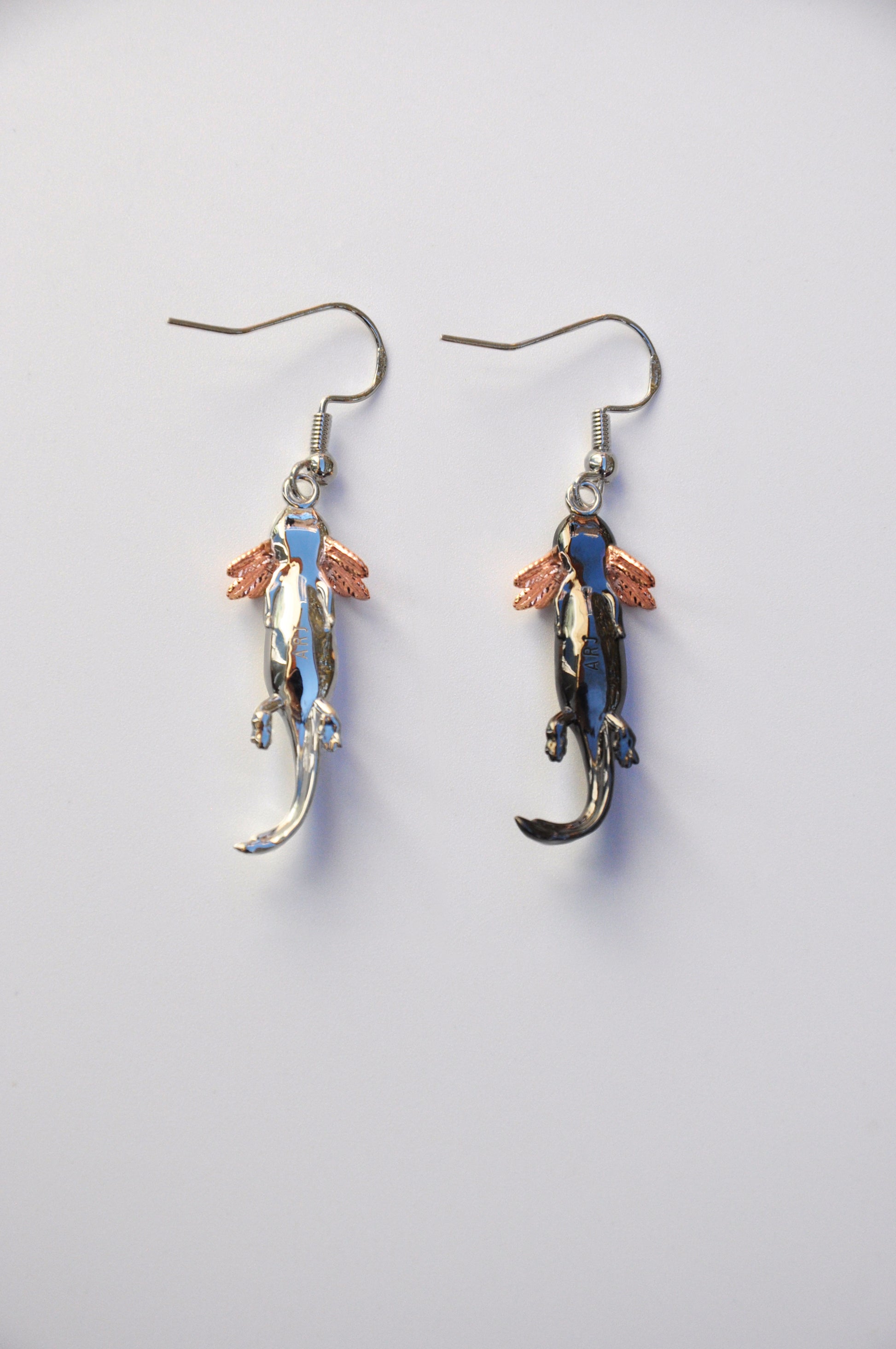 Back view of the Axolotl Drop Earrings on a white background, highlighting the smooth finish and artisan craftsmanship.