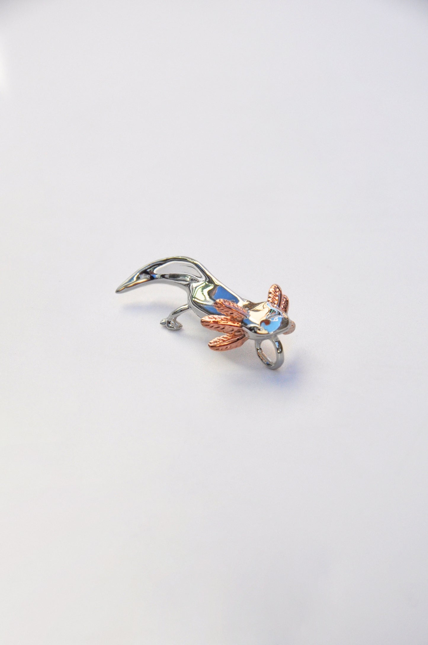 Side view of a real axolotl on a white background, showcasing its frilly gills and gentle expression.