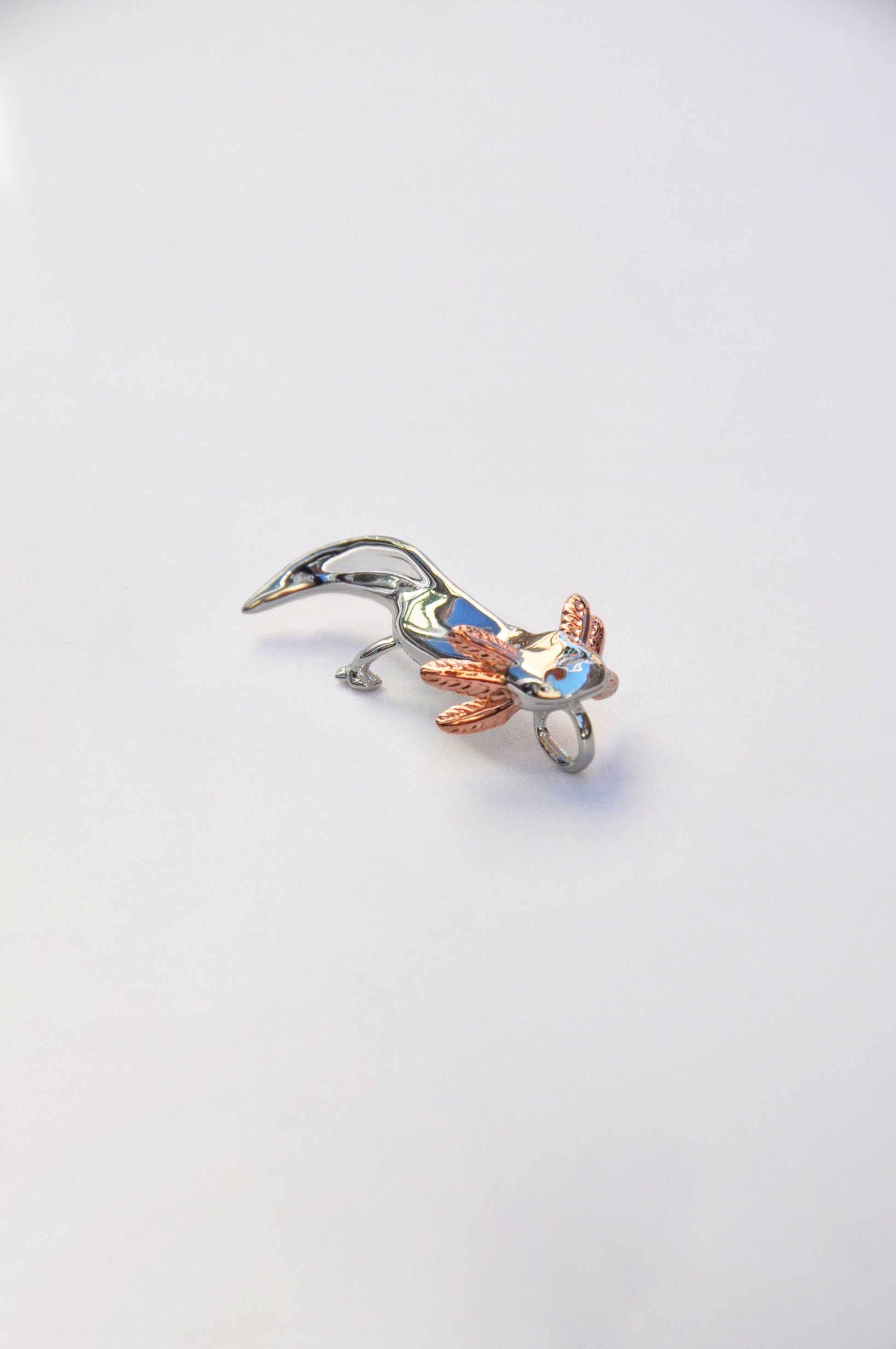 Side view of a real axolotl on a white background, showcasing its frilly gills and gentle expression.