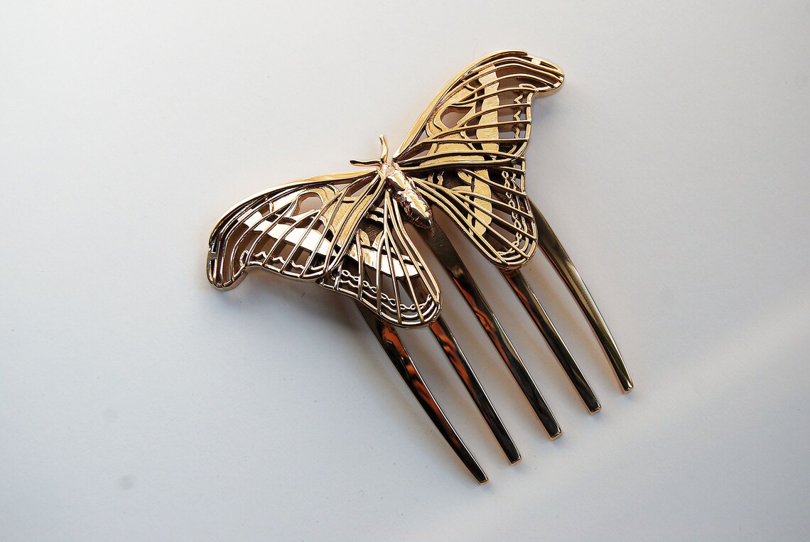 Bronze Atlas Moth sculpture displayed on a white background, highlighting the detailed wing texture and metallic finish of the handcrafted design.