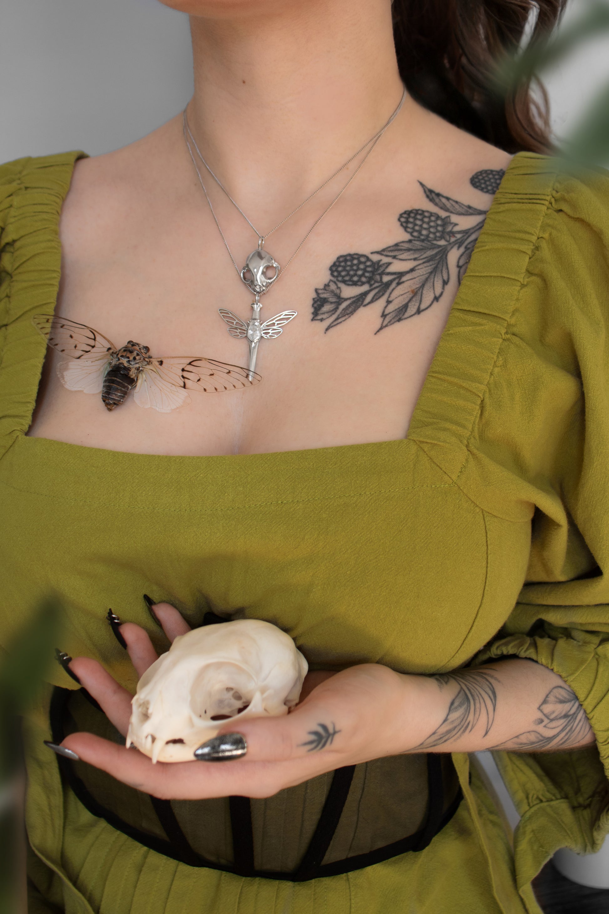 Bug ring-inspired cicada dagger pendant crafted in sterling silver with a glowing white stone