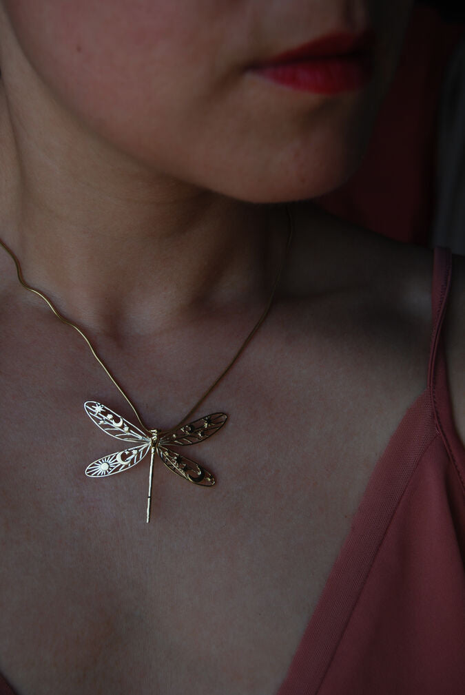 Model wearing gold celestial damselfly pendant necklace