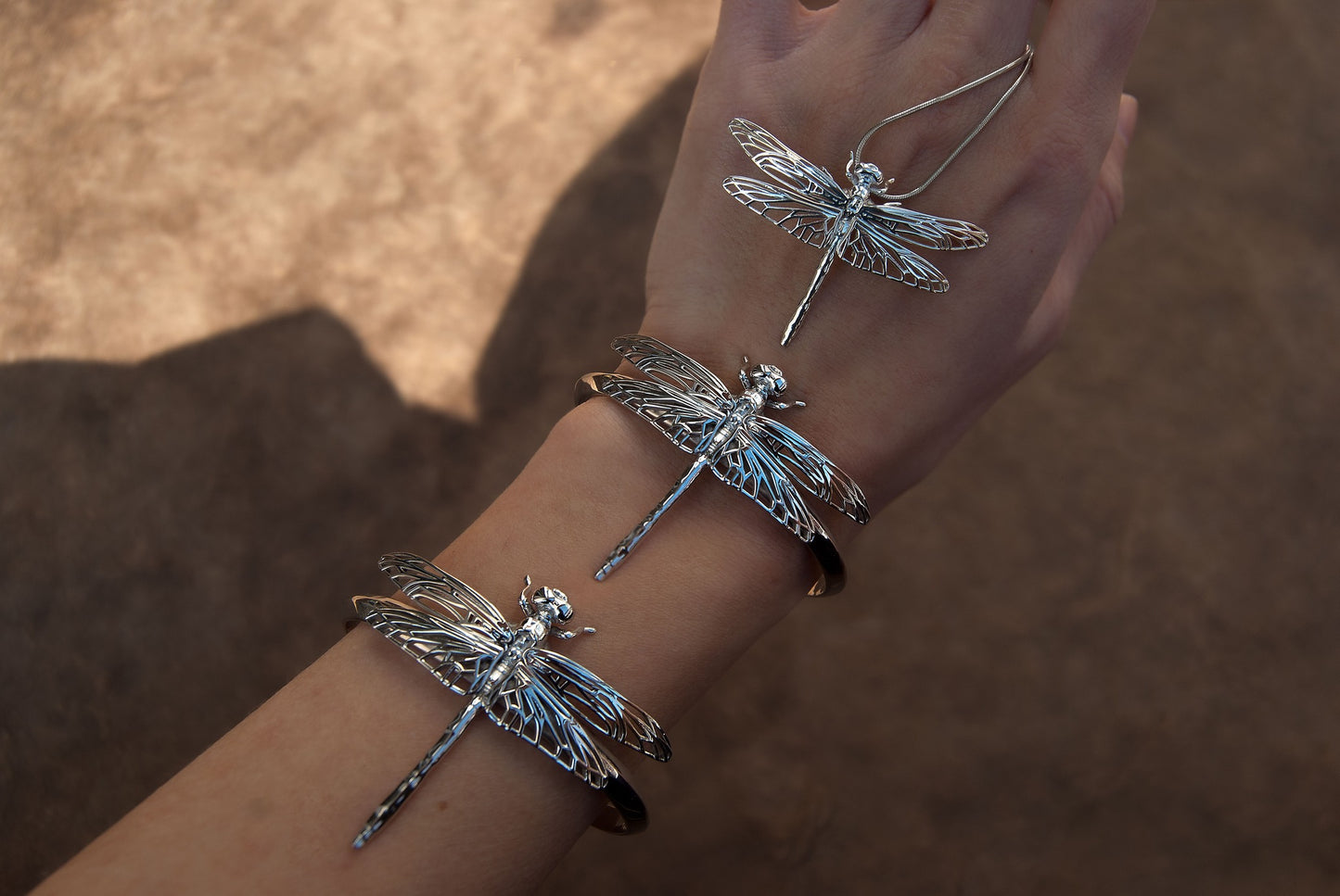 Silver Dragonfly Bracelet and matching pendants displayed together, emphasizing cohesive insect jewelry design.