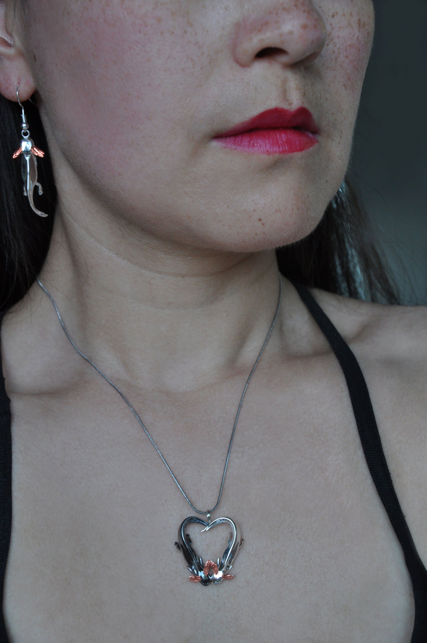 Model wearing the Exolotl Love Pendant and matching axolotl earrings, styled to showcase the whimsical elegance of the set.