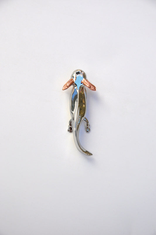 Front view of the handcrafted Exolotl pendant on a white background, showing its sterling silver body and rose gold-plated gills.