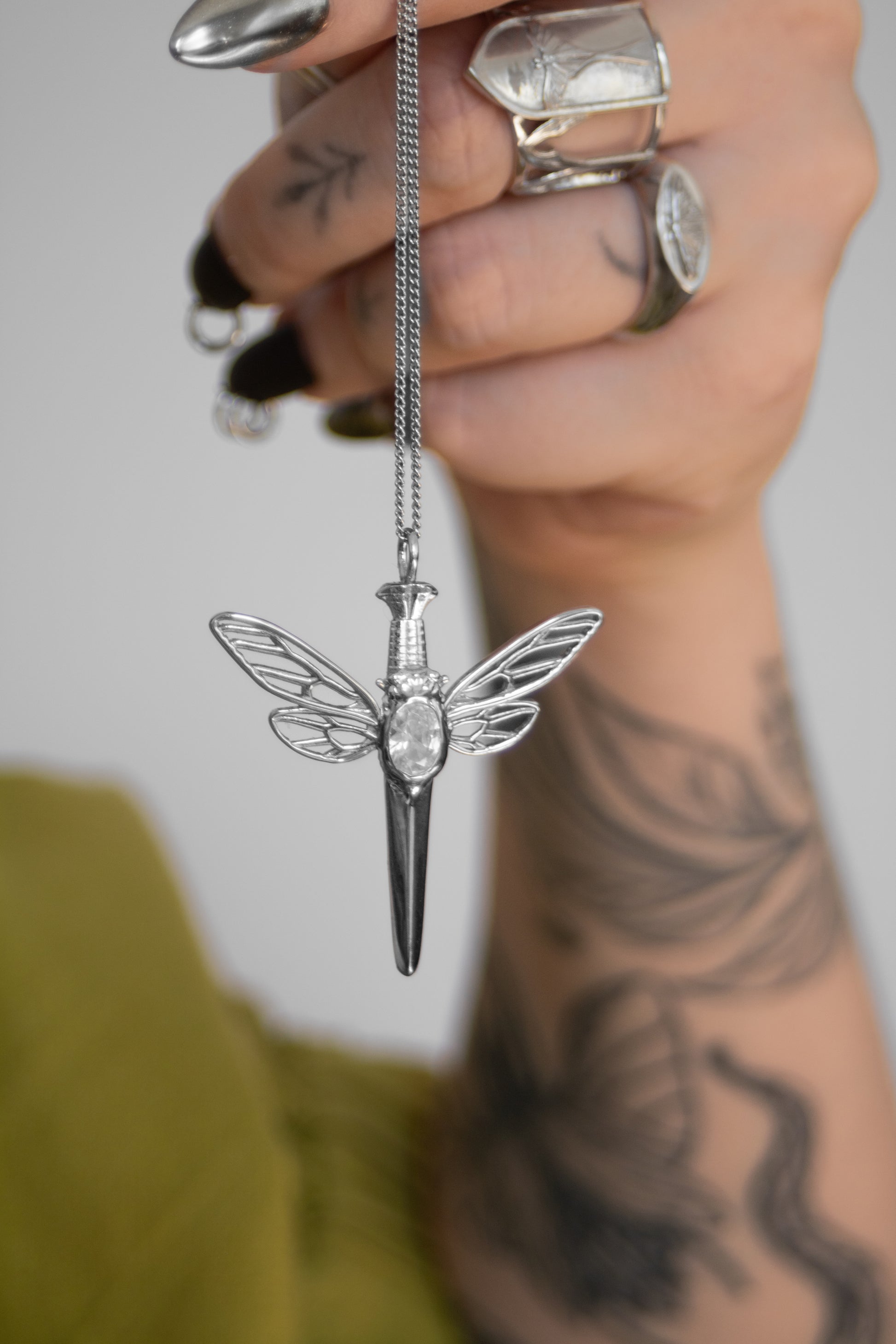 Cicada dagger pendant in sterling silver inspired by insect rings, showcasing transformation and nature’s elegance