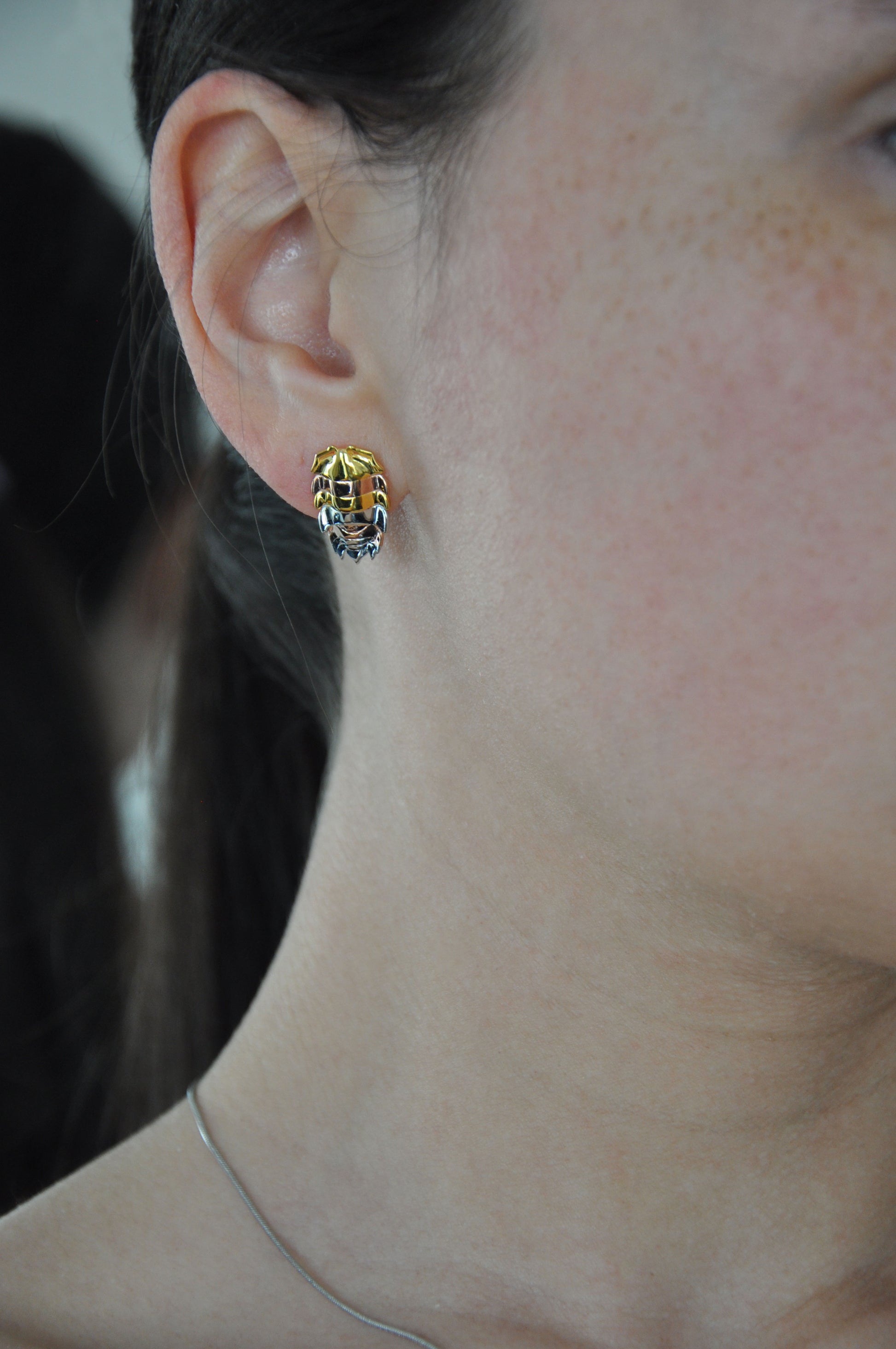 Artistic mixed metal isopod earrings with silver and gold tones, perfect for lovers of insect-inspired stacking rings and bug jewelry
