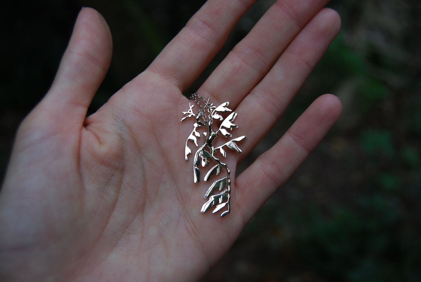 Back view of sterling silver Leafy Sea Dragon Pendant, highlighting smooth polished finish.