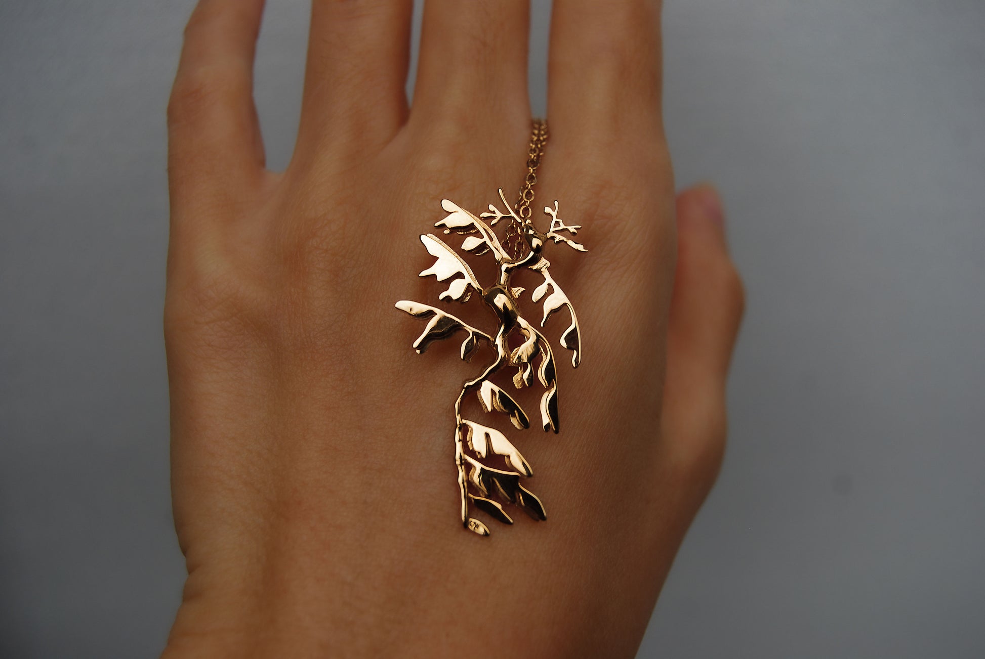 Front view of Leafy Sea Dragon Pendant in 14K gold plated finish, detailed sea life design.