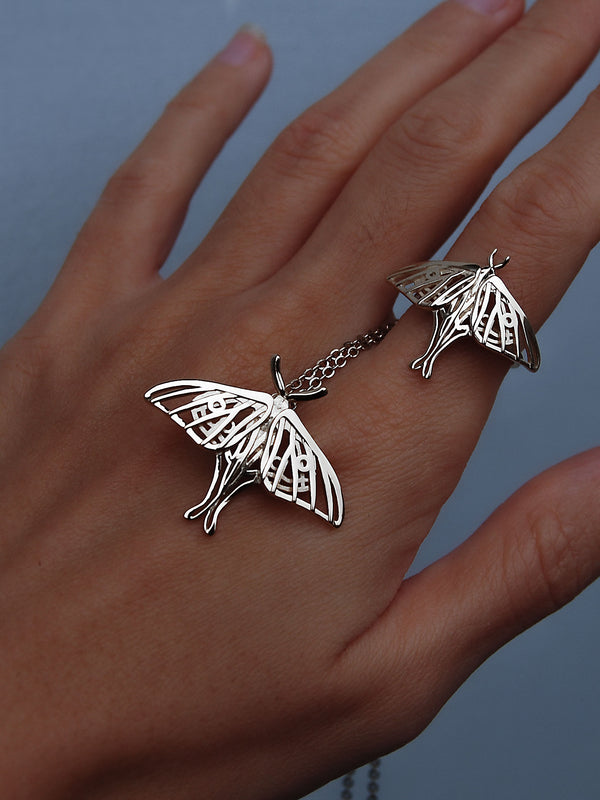 Silver Luna Moth Ring worn on hand alongside matching pendant, highlighting the cohesive moth jewelry set.