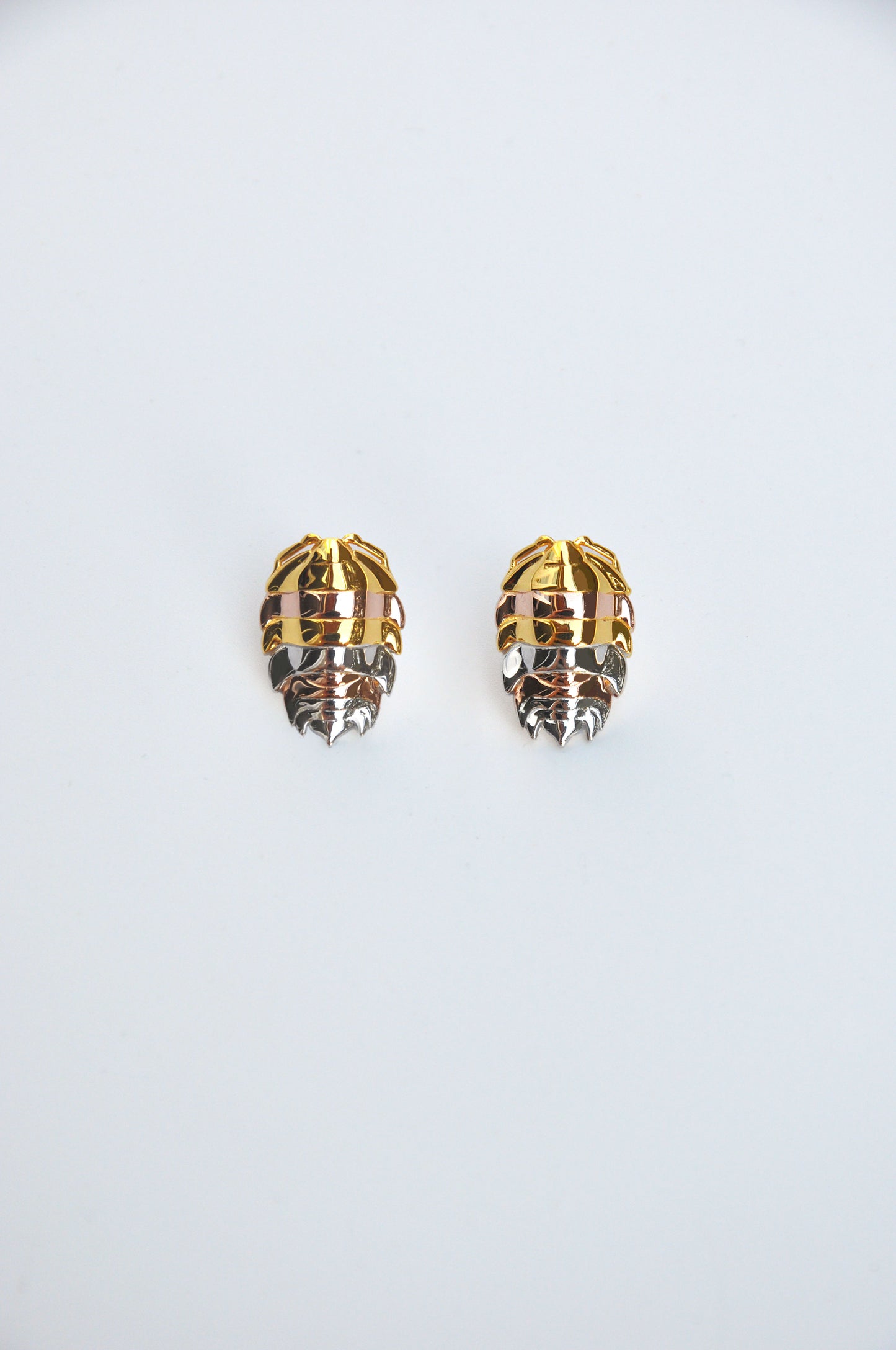 Unique mixed metal rainbow isopod earrings combining silver and 14k gold plated finishes, inspired by bug jewelry trends