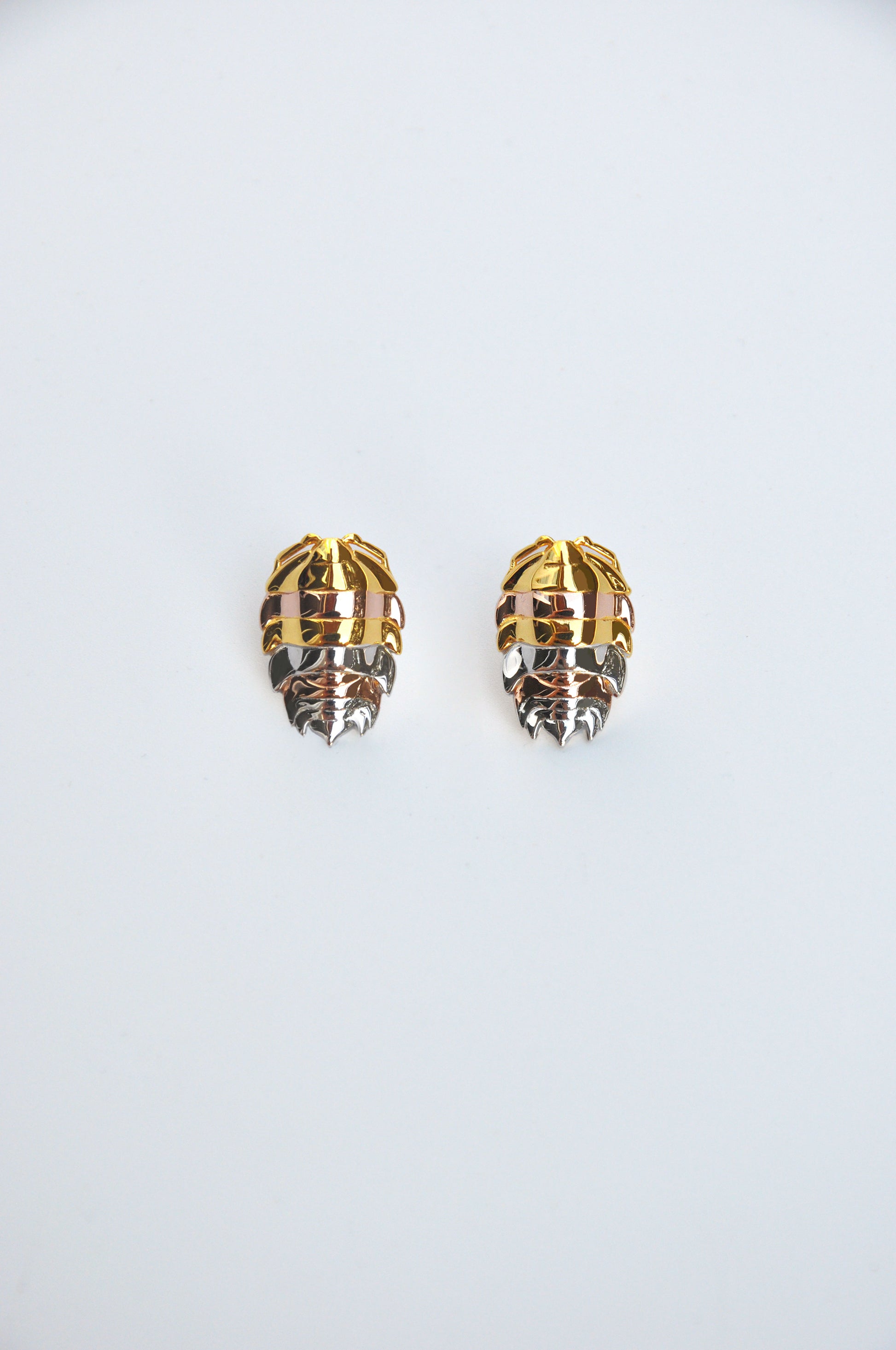 Unique mixed metal rainbow isopod earrings combining silver and 14k gold plated finishes, inspired by bug jewelry trends