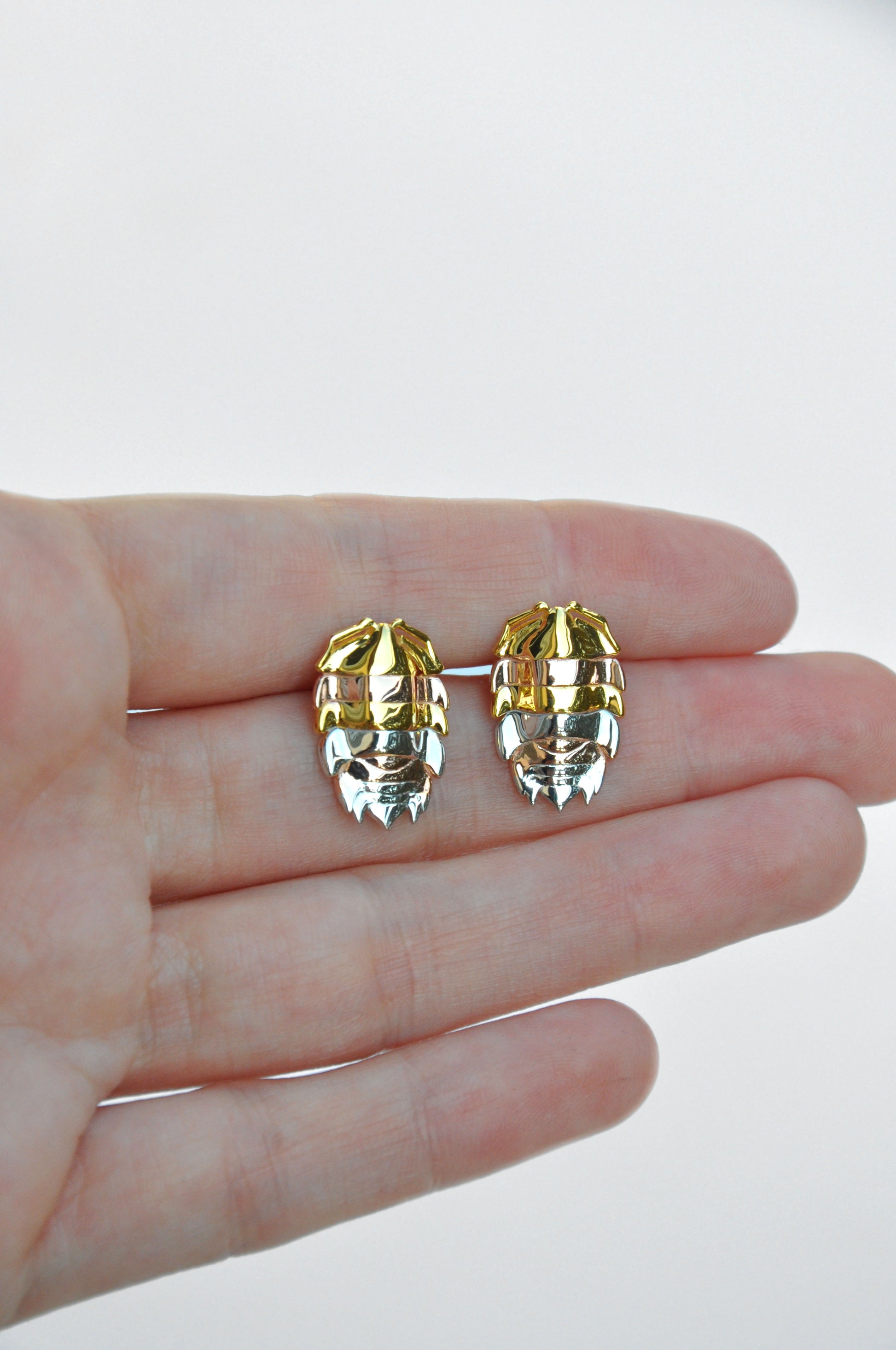 Elegant mixed metal rainbow isopod earrings combining sterling silver and 14k gold plating, inspired by bug and insect jewelry trends