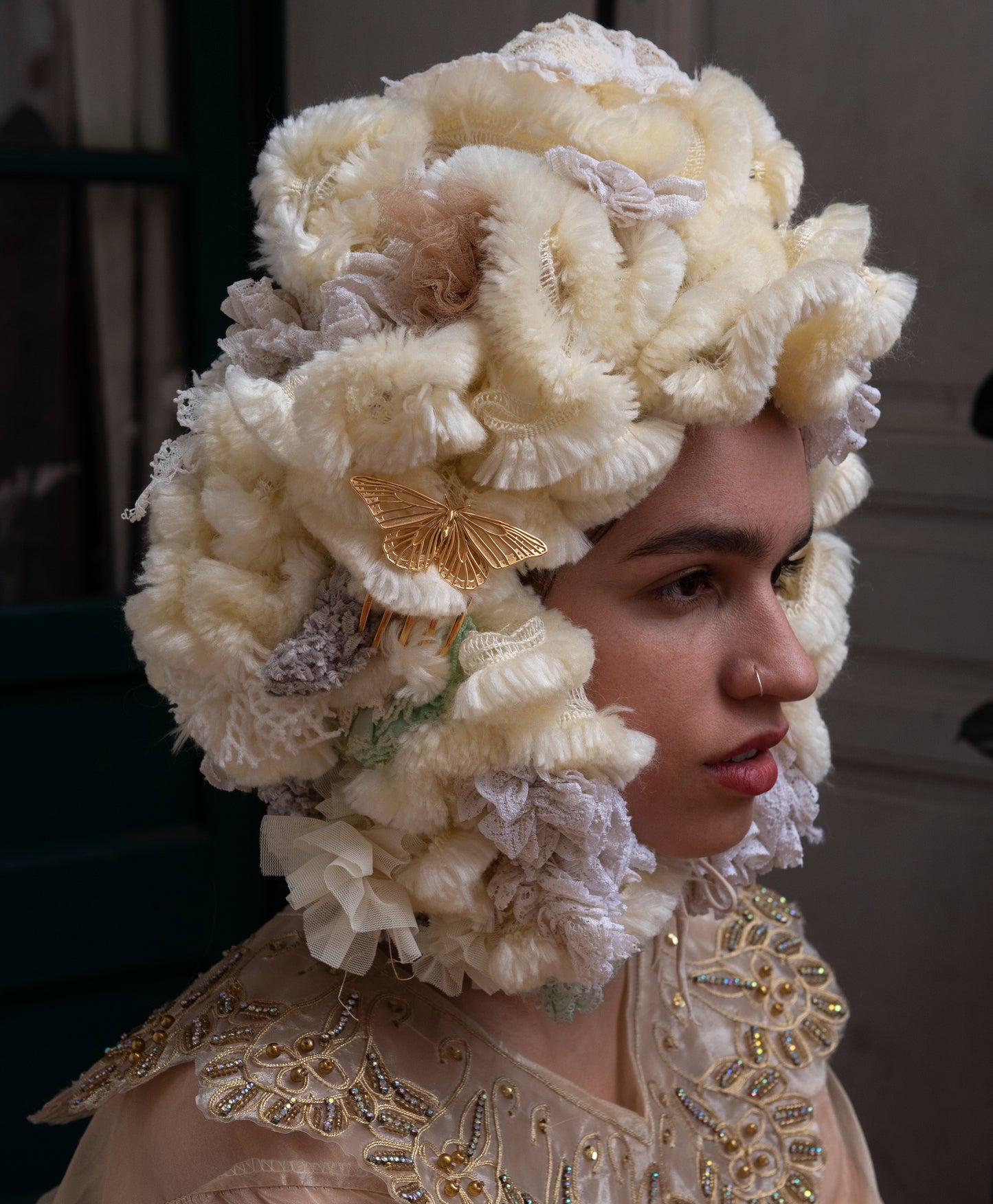 Model adorned with a 14k gold plated Monarch Butterfly hair comb, captured in a dreamlike fantasy portrait. The shimmering gold wings nestle into flowing locks, surrounded by soft light and mystical textures, conjuring the aura of a forest queen or enchanted wanderer.