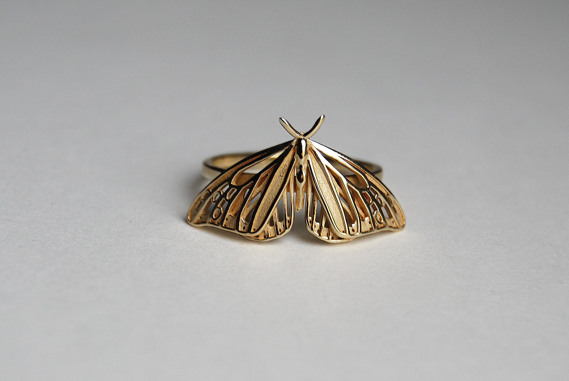 Gold Monarch Butterfly ring with Art Nouveau design on white background