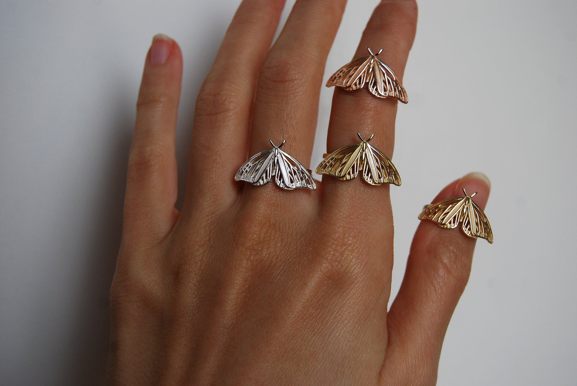 Trio of Monarch Butterfly rings in gold, rose gold, and silver finishes