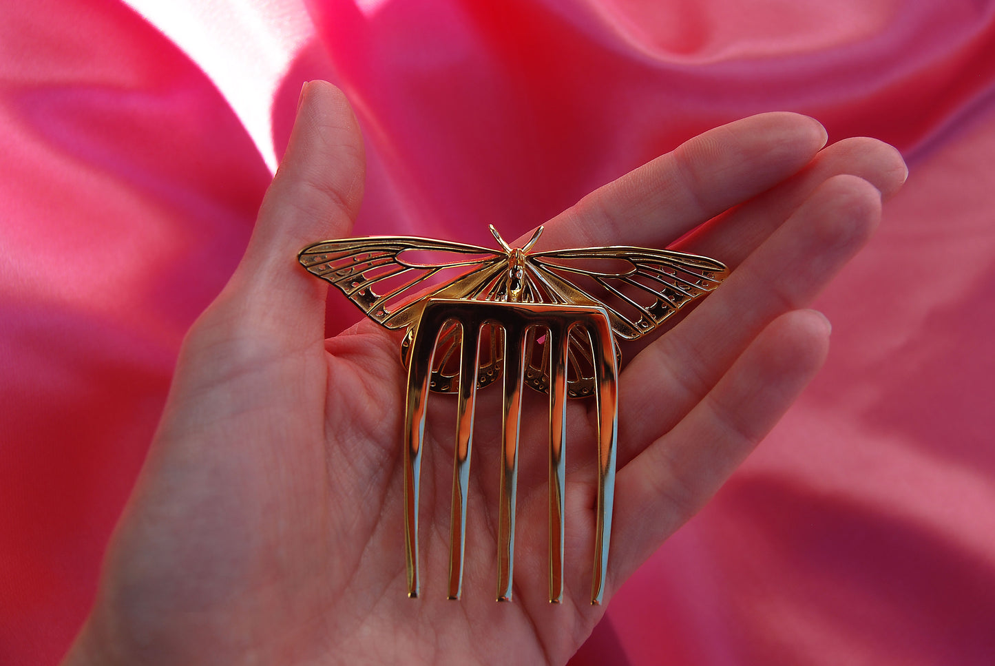 Back view of Monarch Butterfly hair comb in 14k gold plated brass, displayed on a silk background. The comb’s polished prongs and smooth backing highlight its refined craftsmanship and elegant structure.